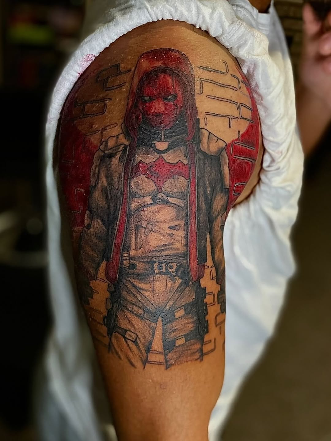 Red Hood character realism tattoo on the thigh by Jelani