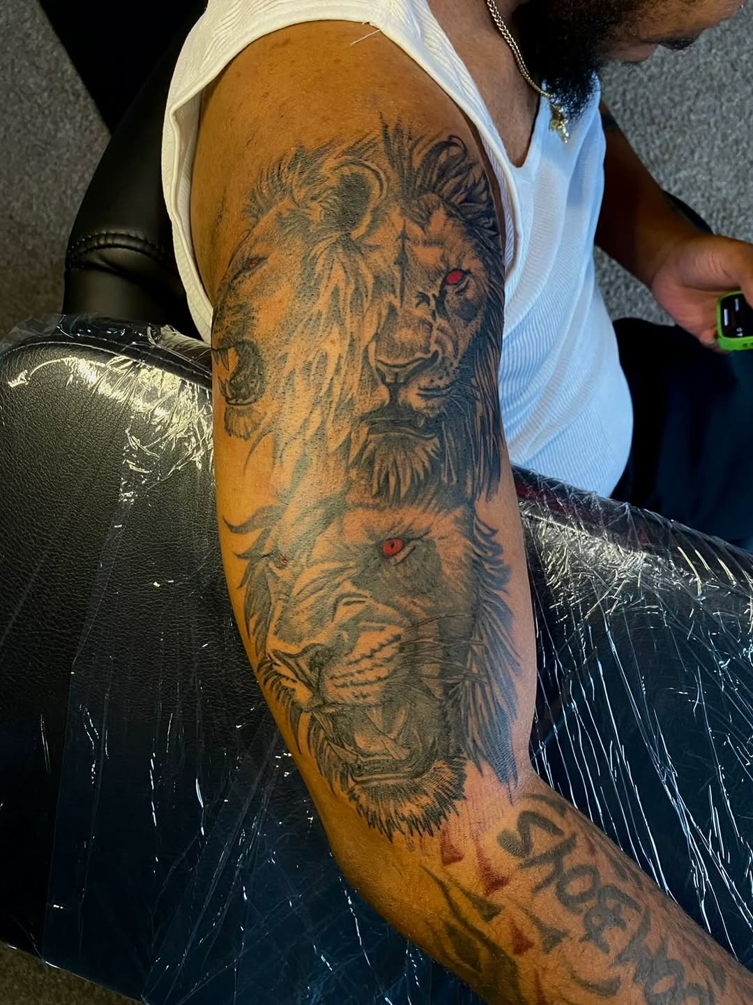 Two lions realism tattoo on the forearm by Jelani