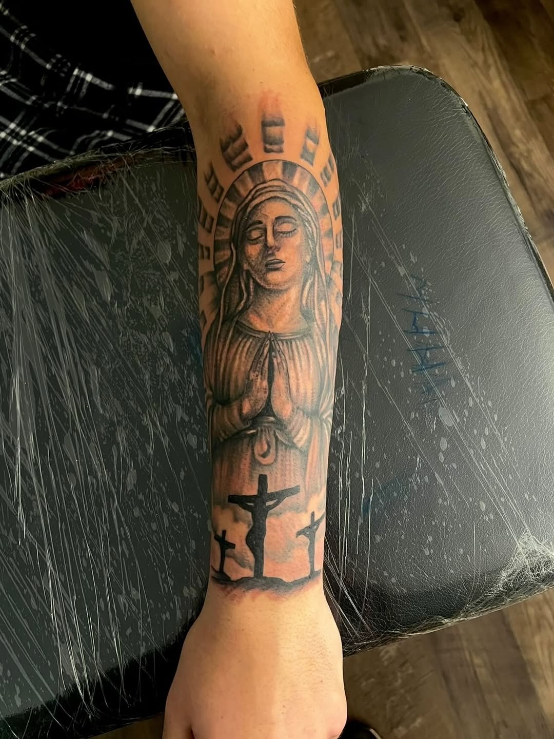 Virgin Mary and crucifixions Chicano tattoo on the forearm by Jelani