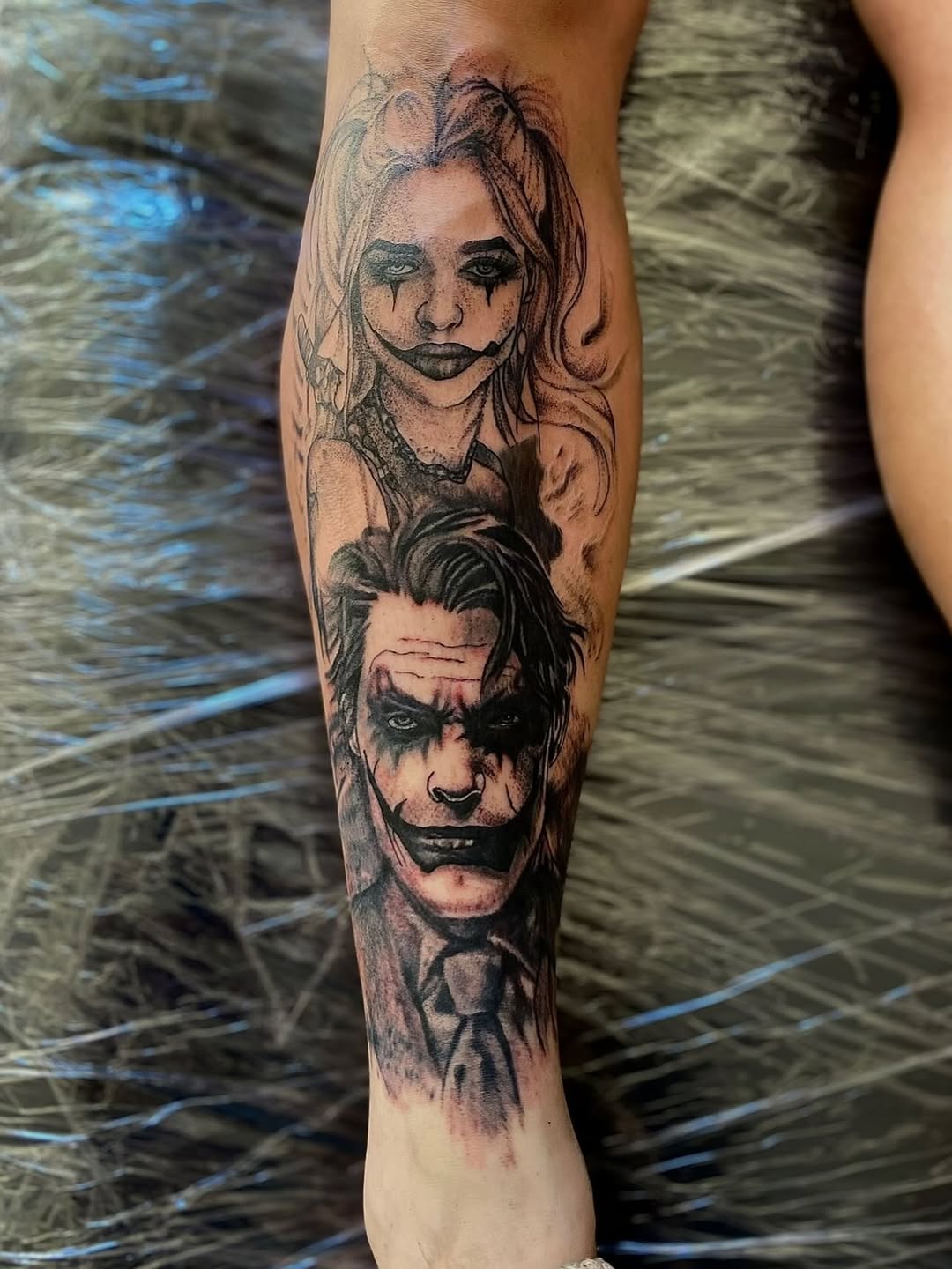 Joker and Harley Quinn portraits realism tattoo on the forearm by Jelani