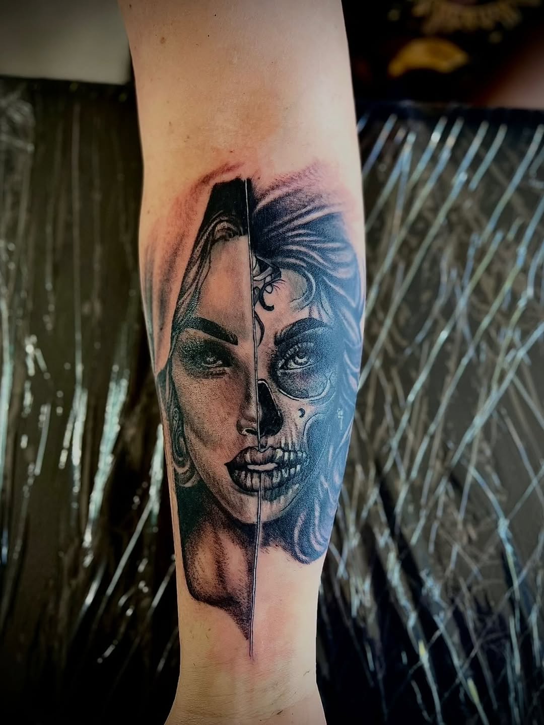Split face portrait, woman and skull sketch tattoo on the forearm by Jelani