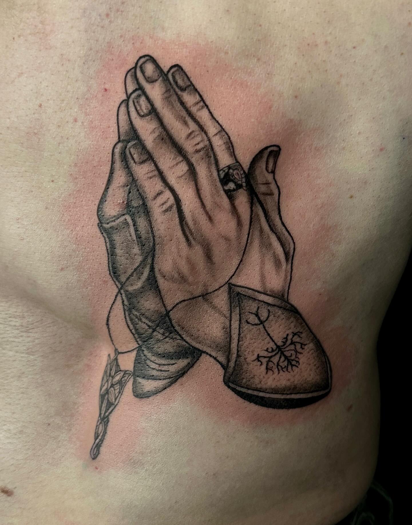 Praying hands realism tattoo on the chest by Mika'la Berry