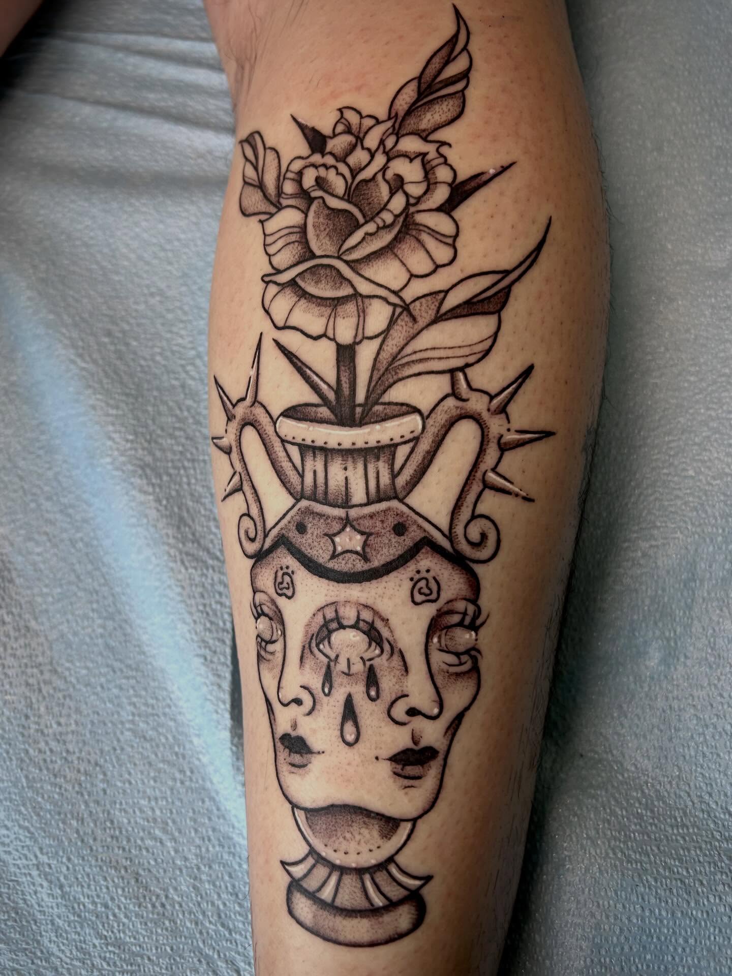 Skeleton head with flowers black and grey tattoo on the forearm by Bria🩸