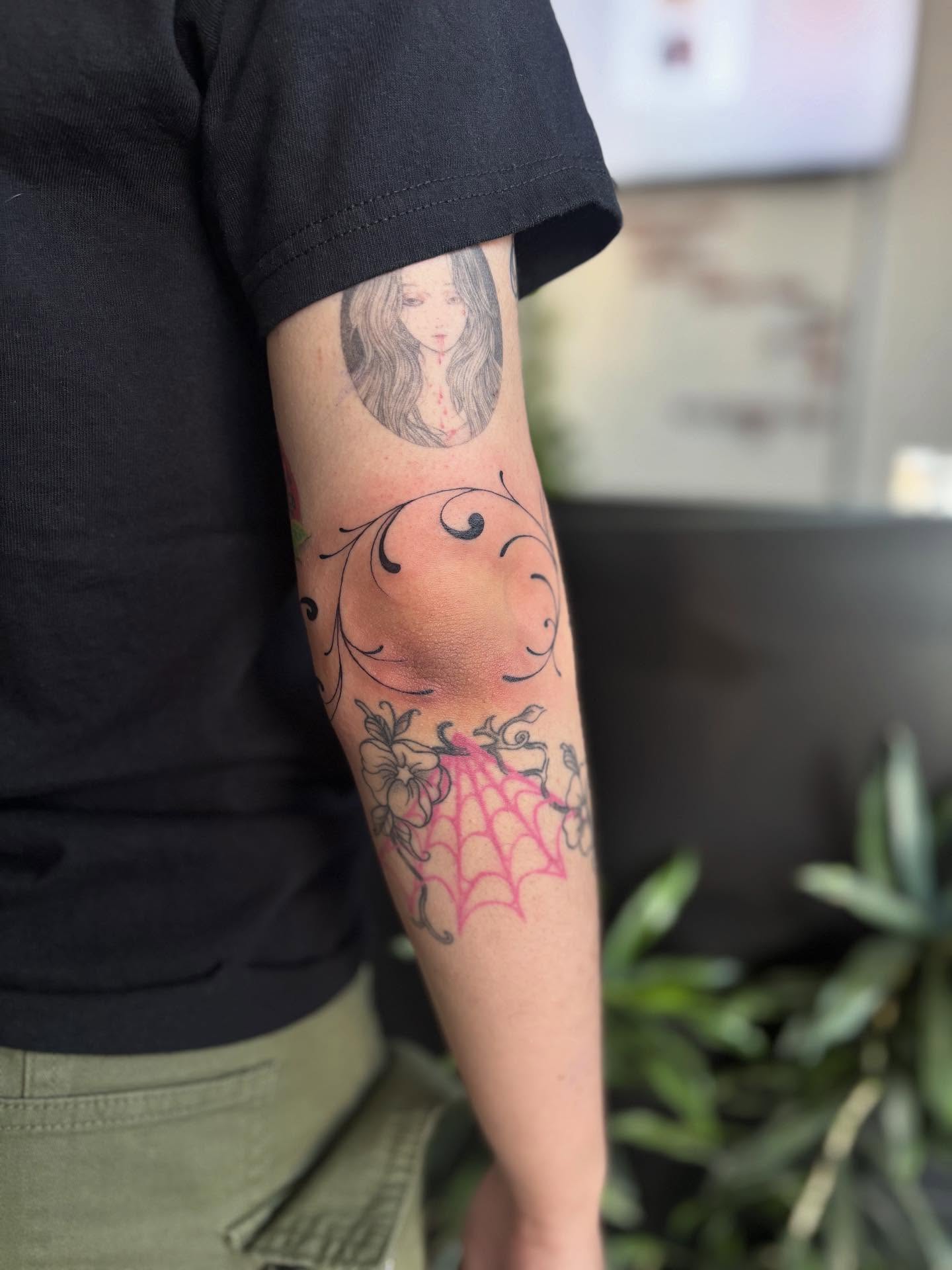 Spider web and flowers dotwork tattoo on the forearm by Marissa Whitaker