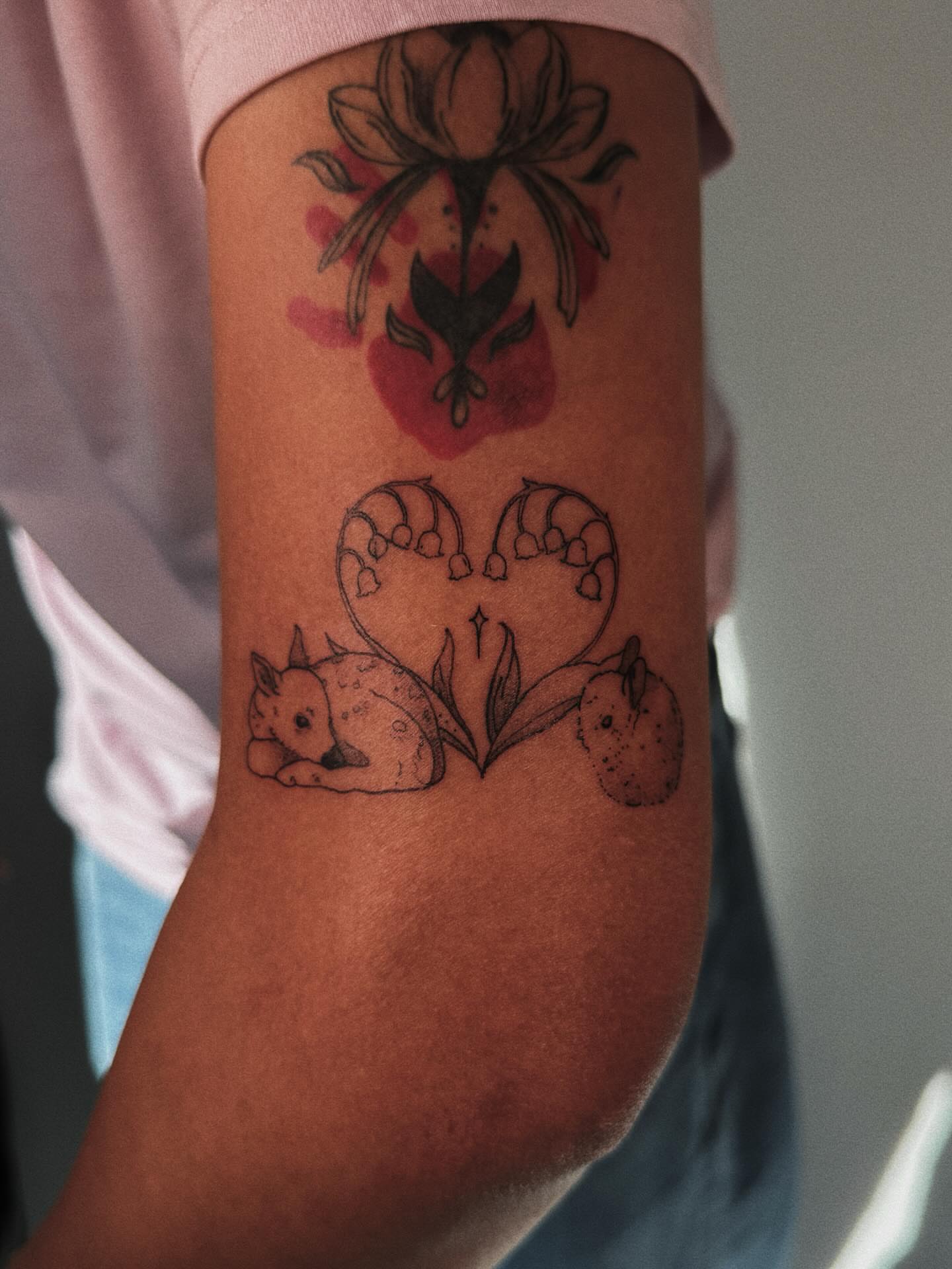 Fox and lily of the valley black and grey tattoo on the forearm by Paulina Vazquez
