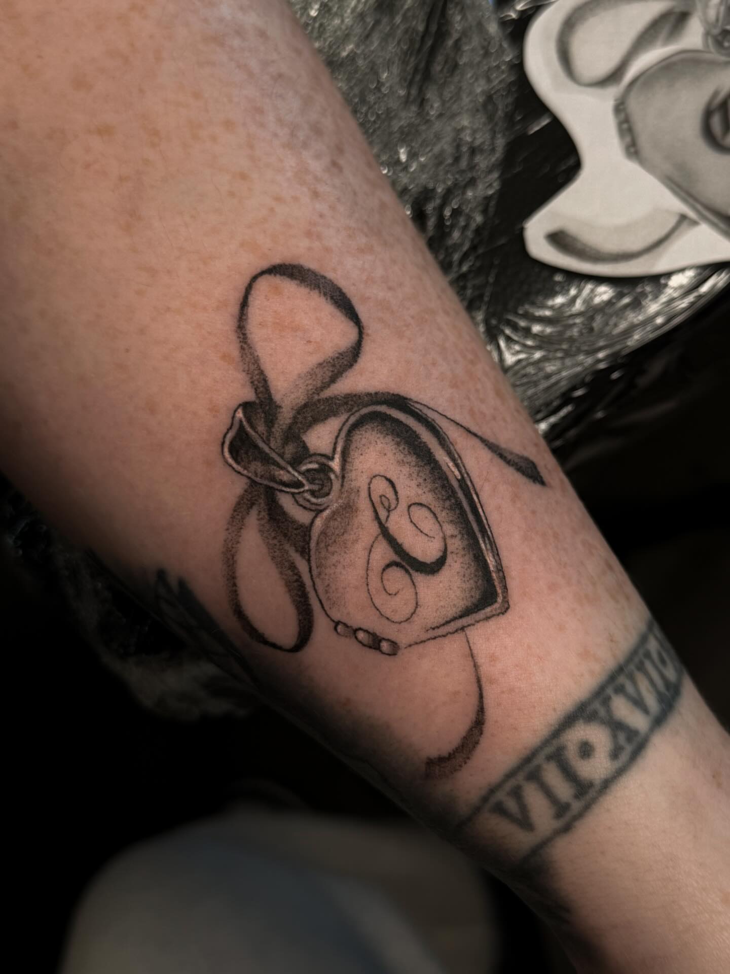 Camera black and grey tattoo on the forearm by Susie Maj