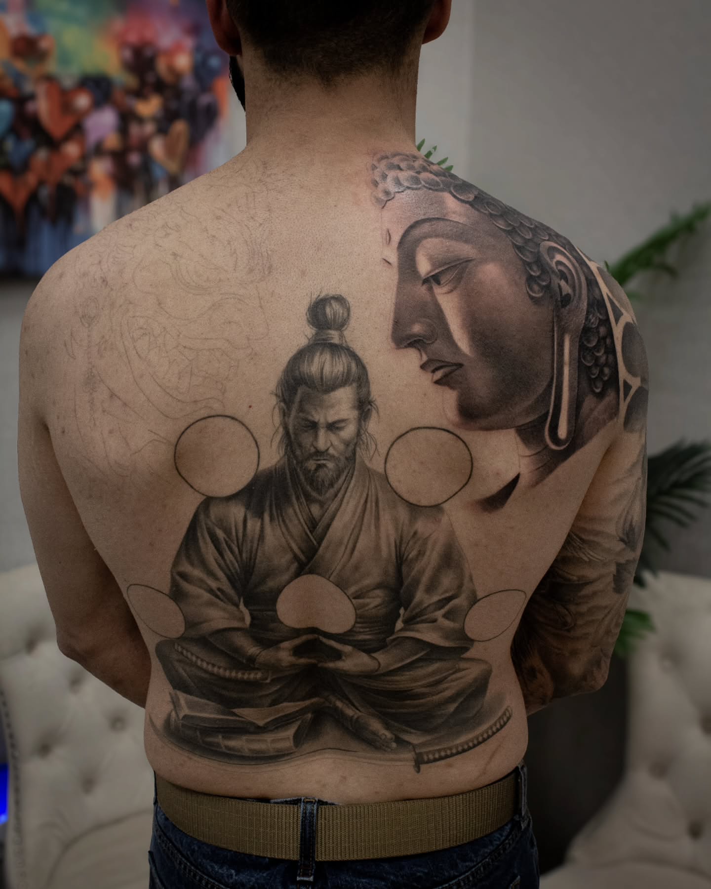 Meditation scene realism tattoo on the back by Erik Bonilla