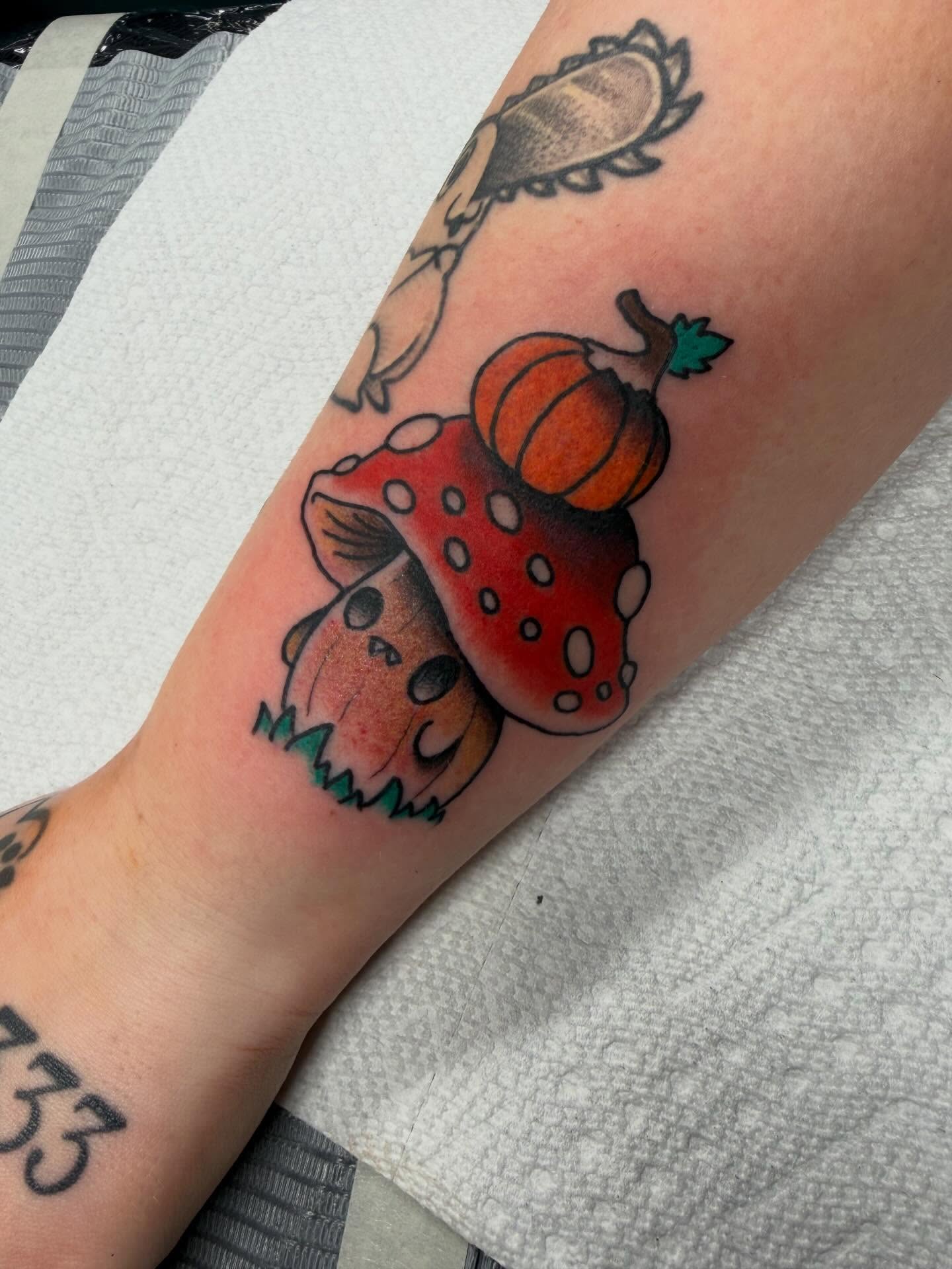Mushroom and pumpkin American traditional tattoo on the forearm by April Morris ⚔️ Tattoo Goblin