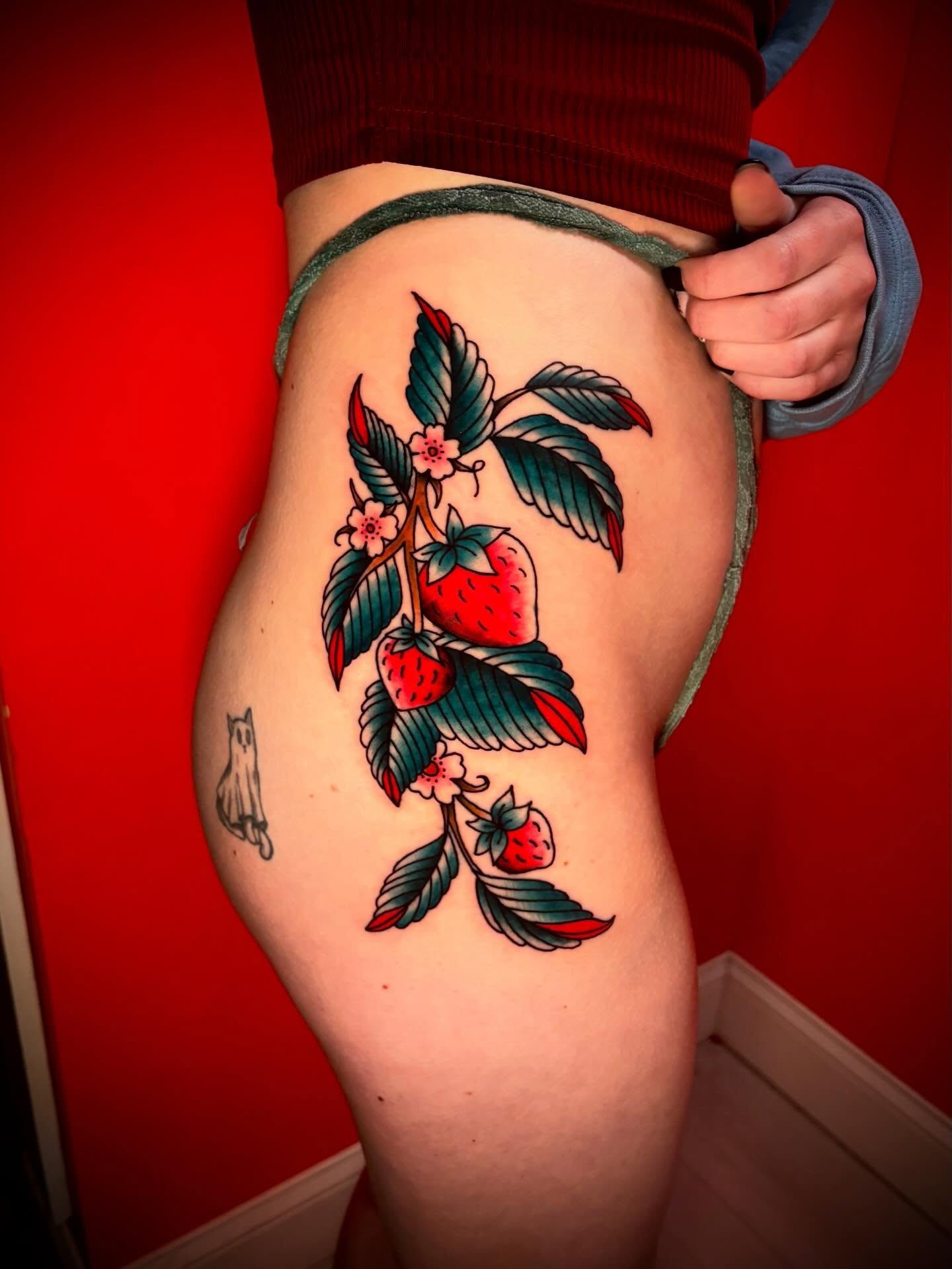 Strawberry plant American traditional tattoo on the thigh by JD Bassett
