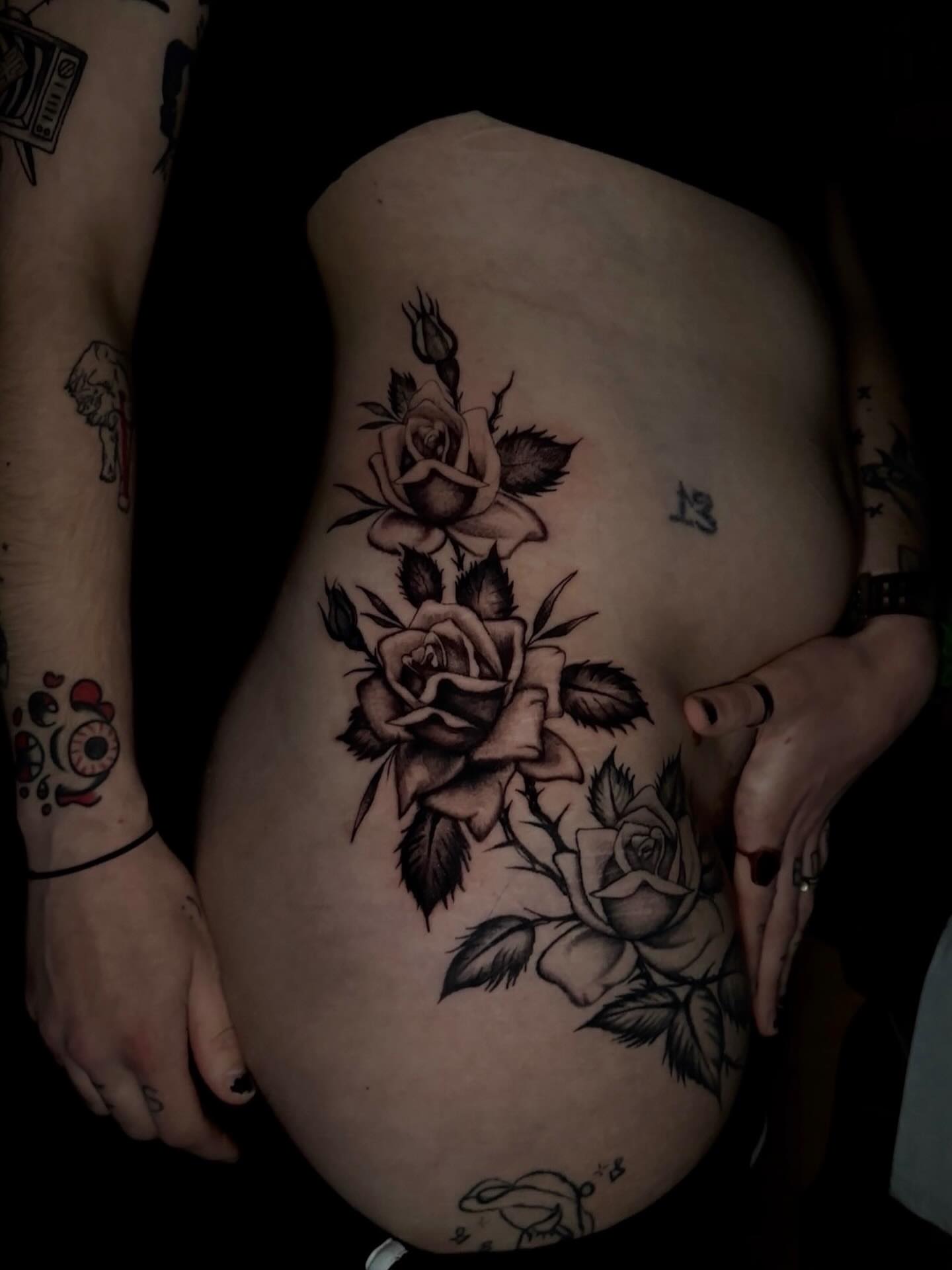 Roses black and grey tattoo on the ribs by Olive Kelley