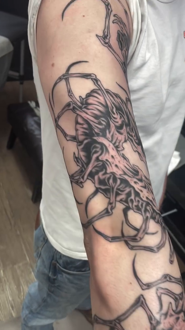 Creature with tendrils blackwork tattoo on the forearm by Brayden P Tattoo