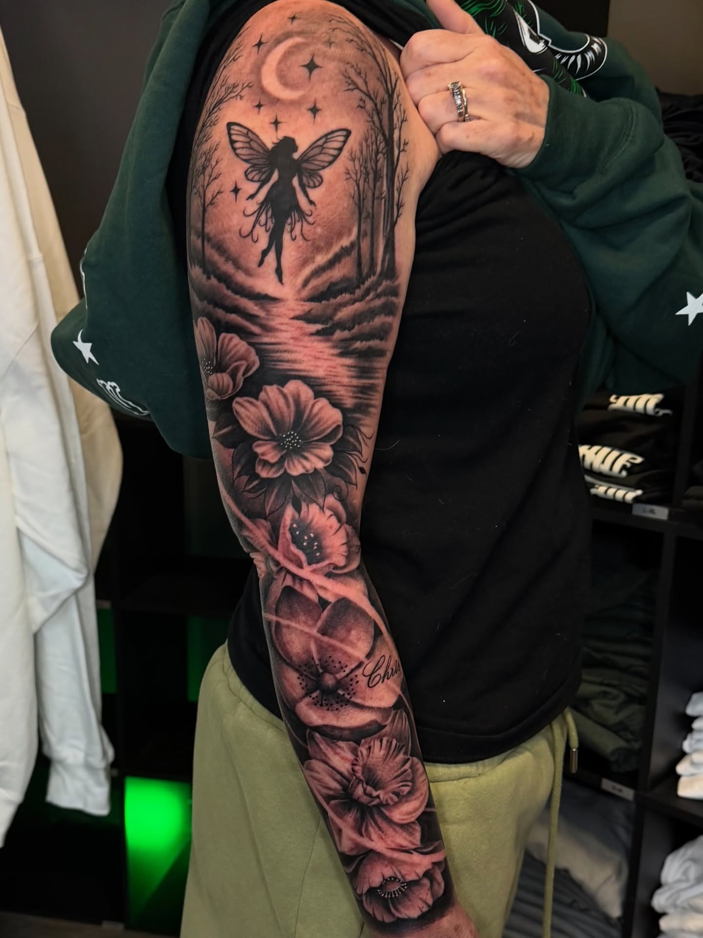 Fairy and flowers realism tattoo on the upper arm by Connor Arvay