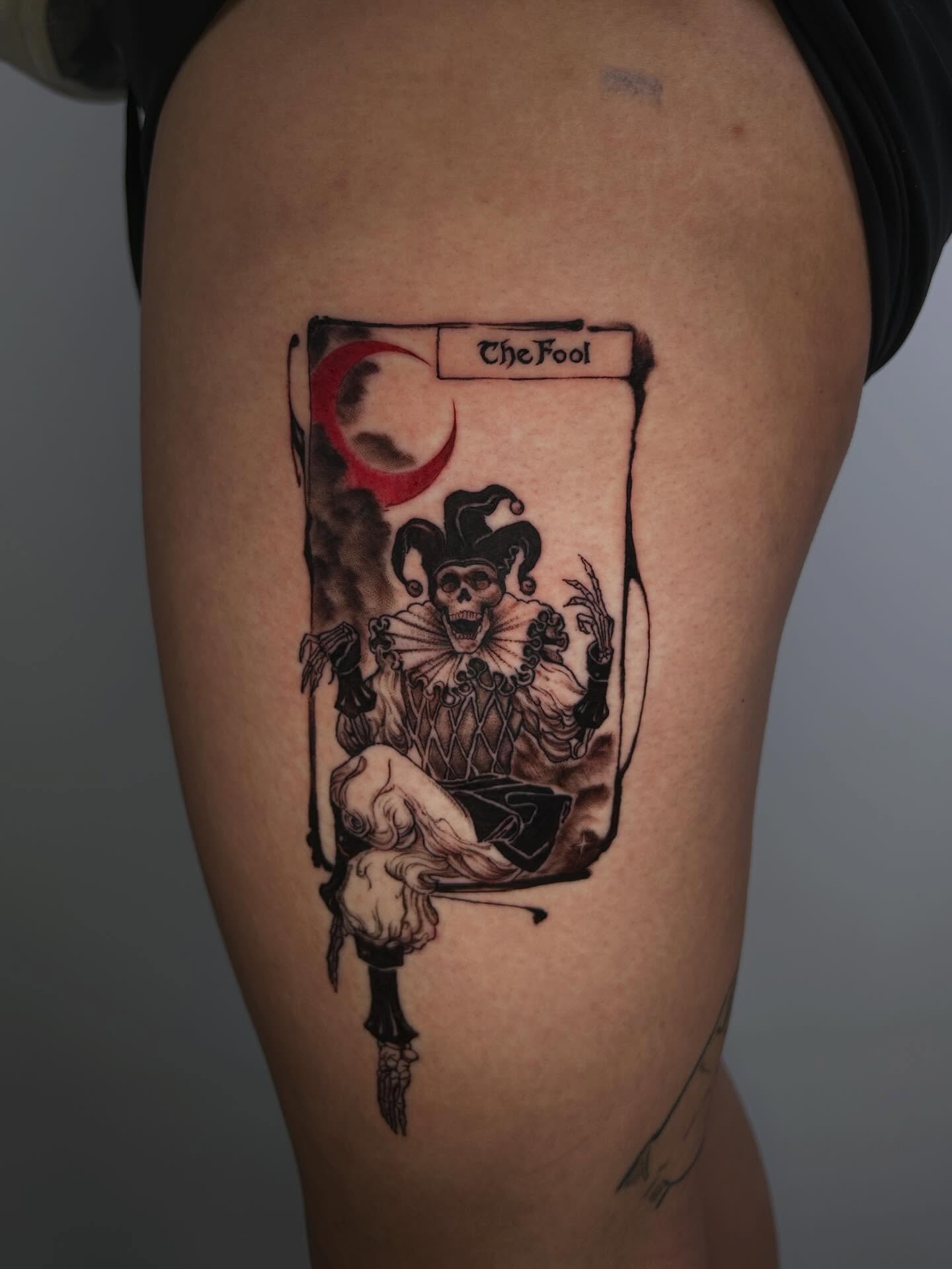 The fool tarot card black and grey tattoo on the thigh by J