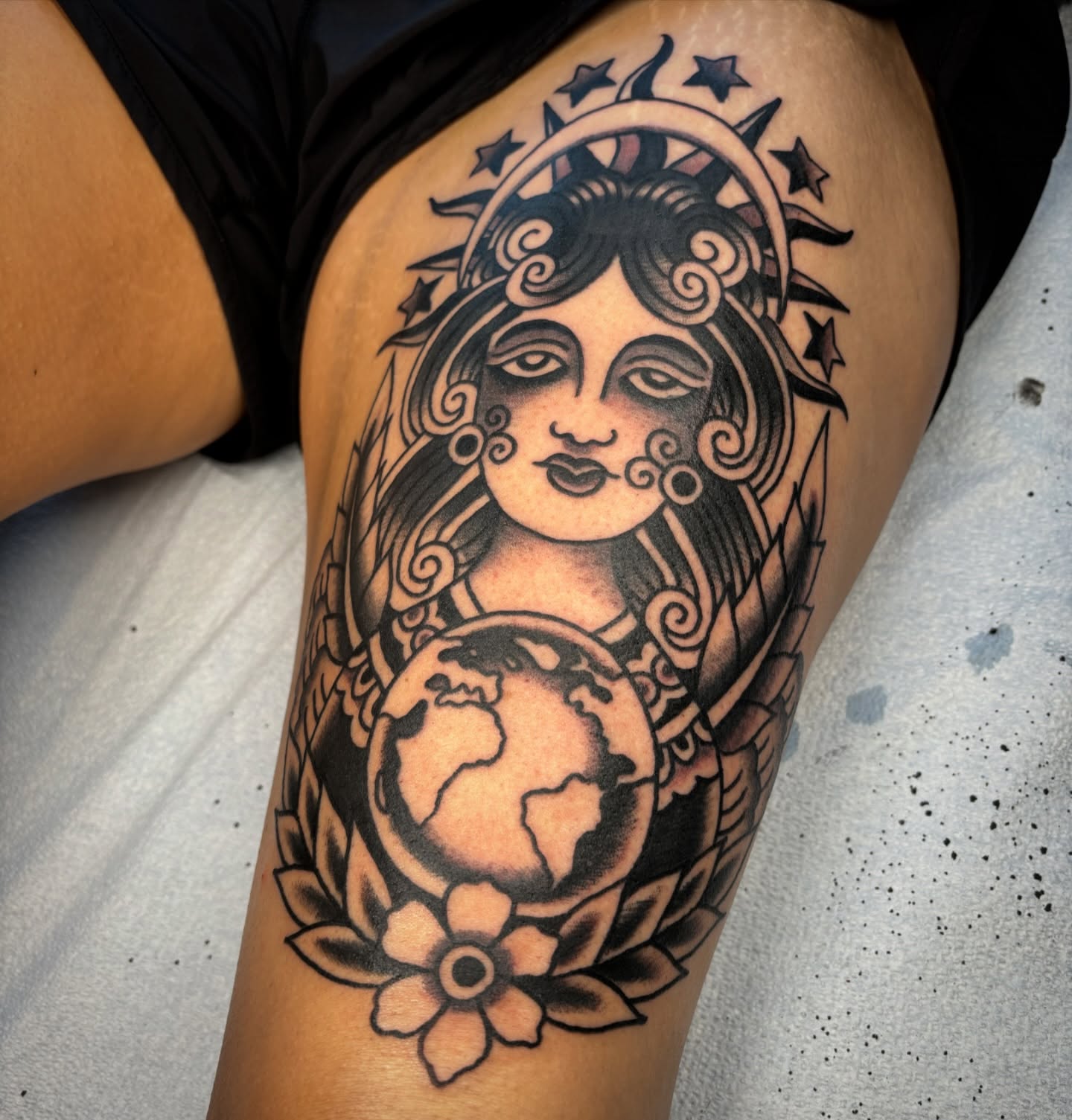 Goddess with globe geometric tattoo on the thigh by Jeff Slack