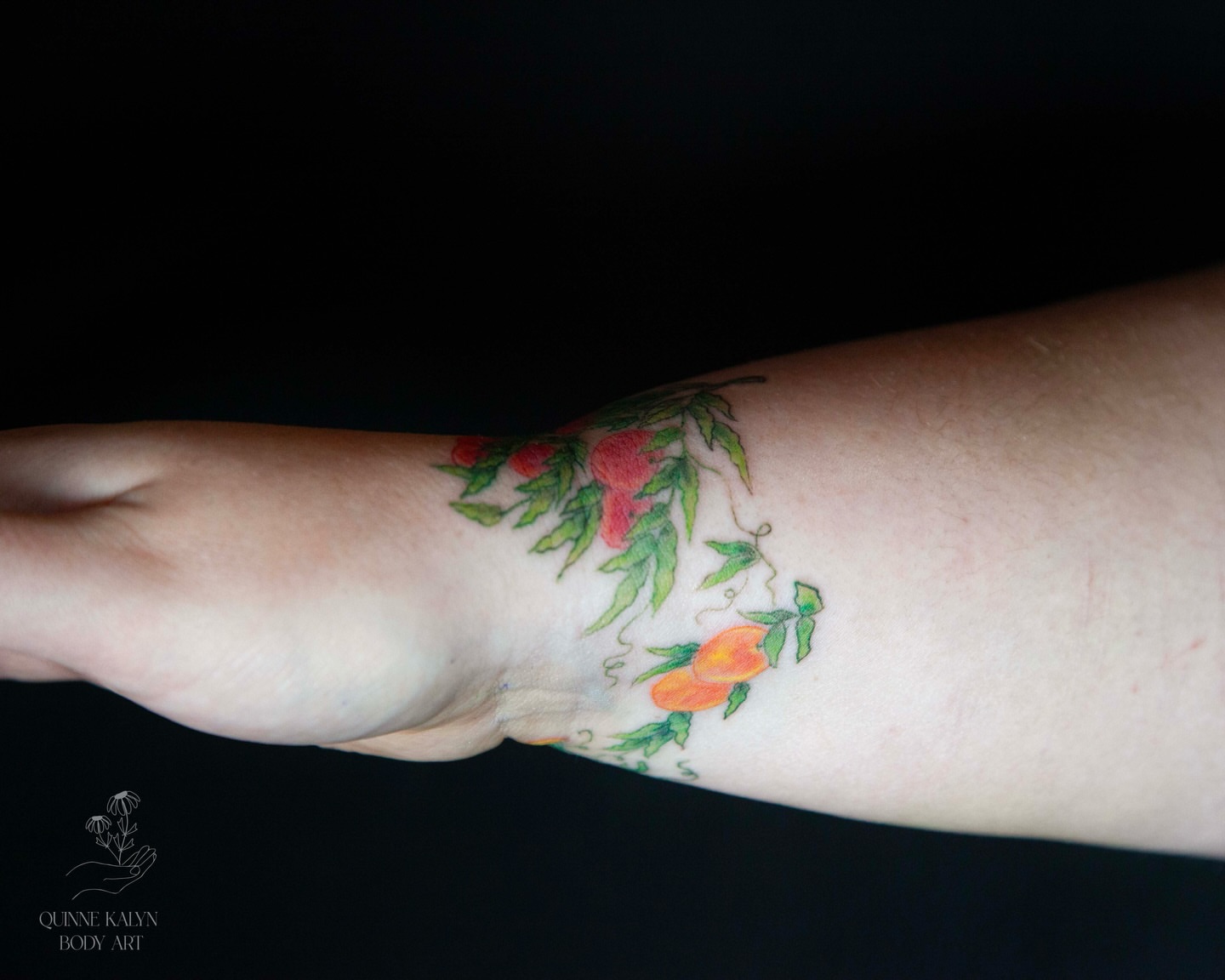 Peach vine watercolor tattoo on the forearm by Nashville Piercer & Tattoo Artist ✨ Quinne