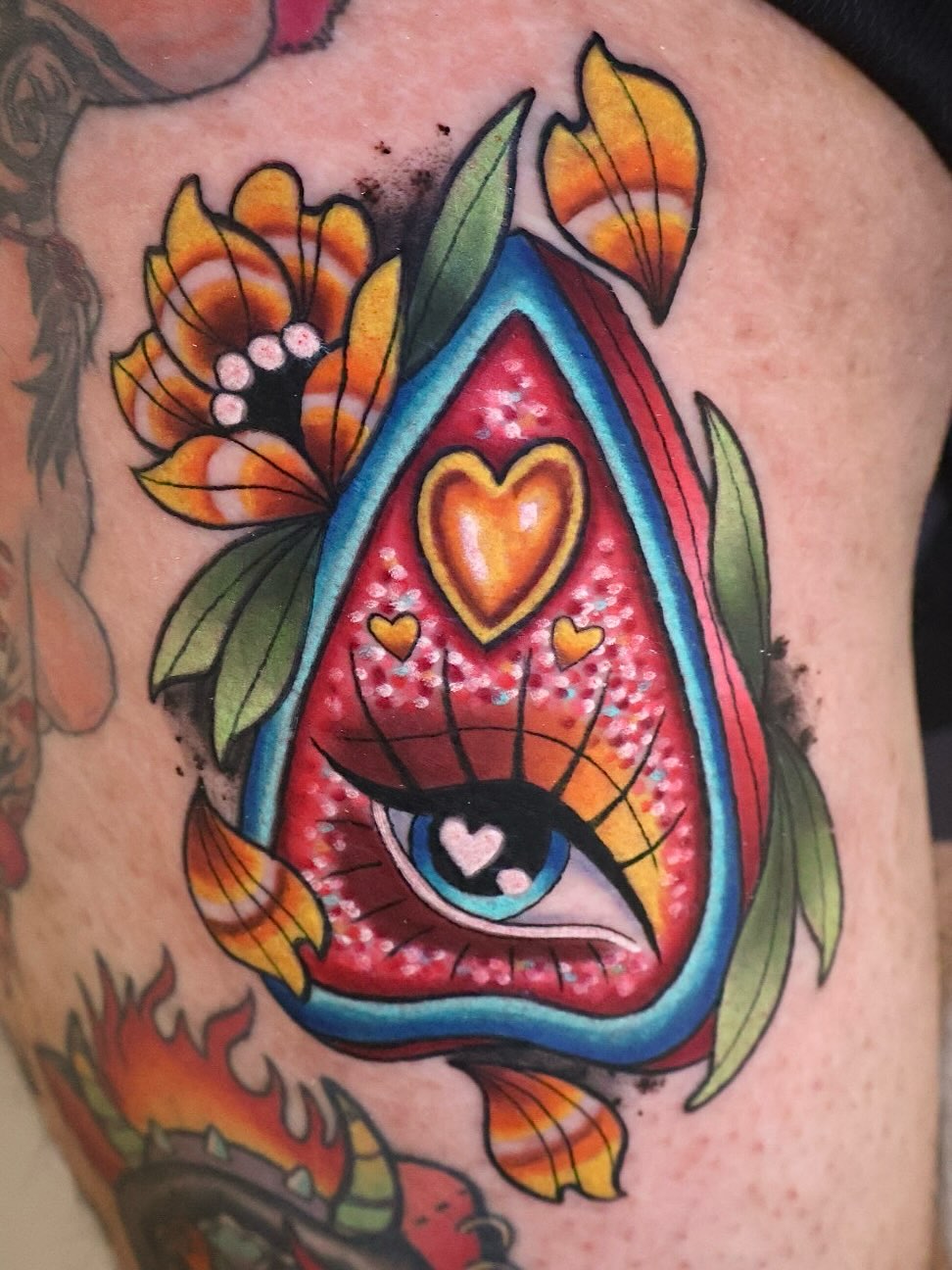 Eye with heart American traditional tattoo on the thigh by Bailey Drey