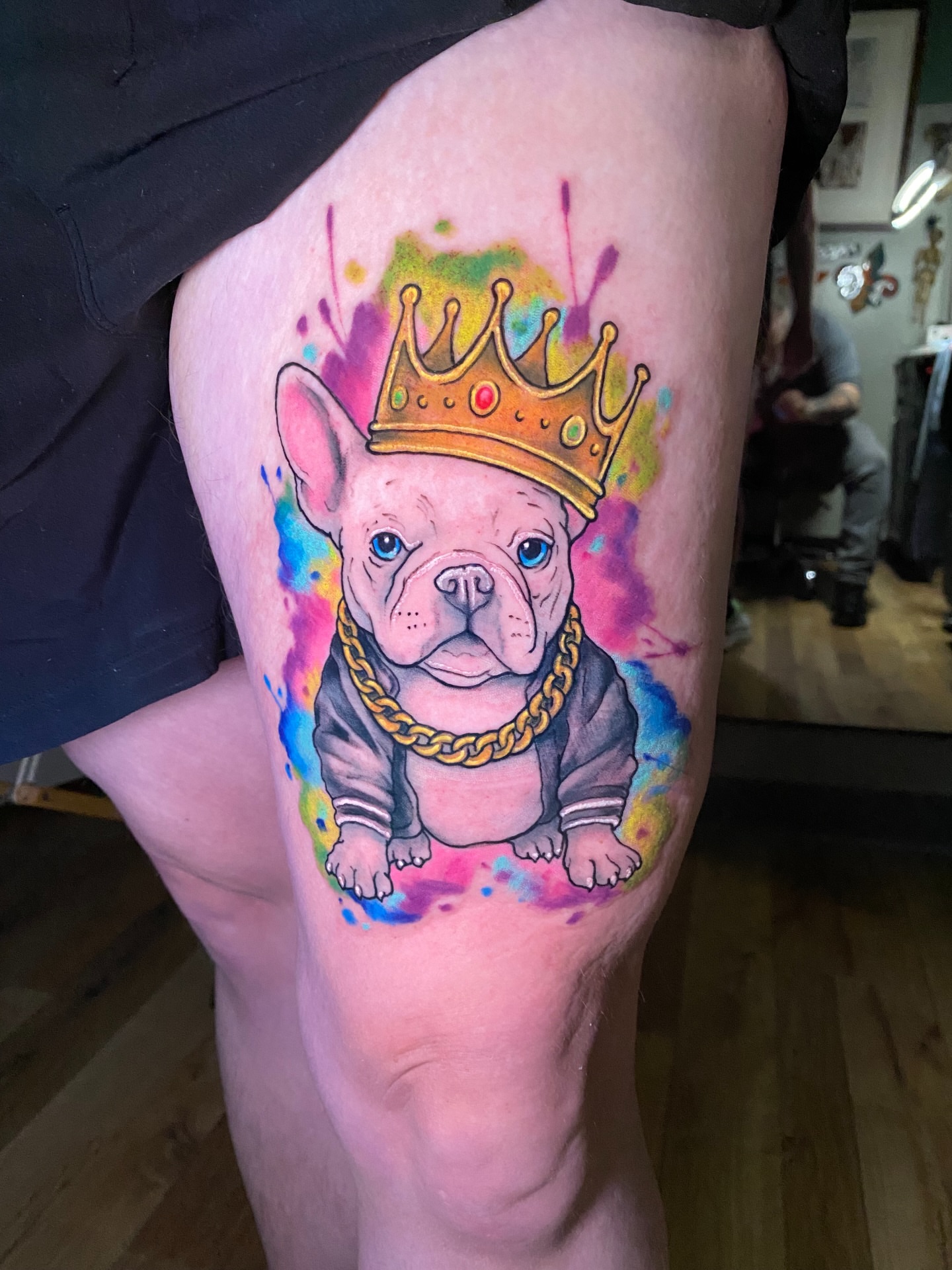 Bulldog wearing crown watercolor tattoo on the thigh by Loki Shane DeFriece