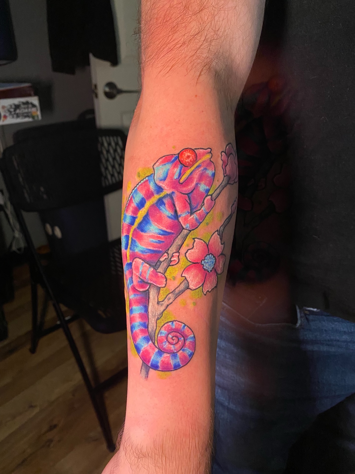 Chameleon and flowers watercolor tattoo on the forearm by Loki Shane DeFriece