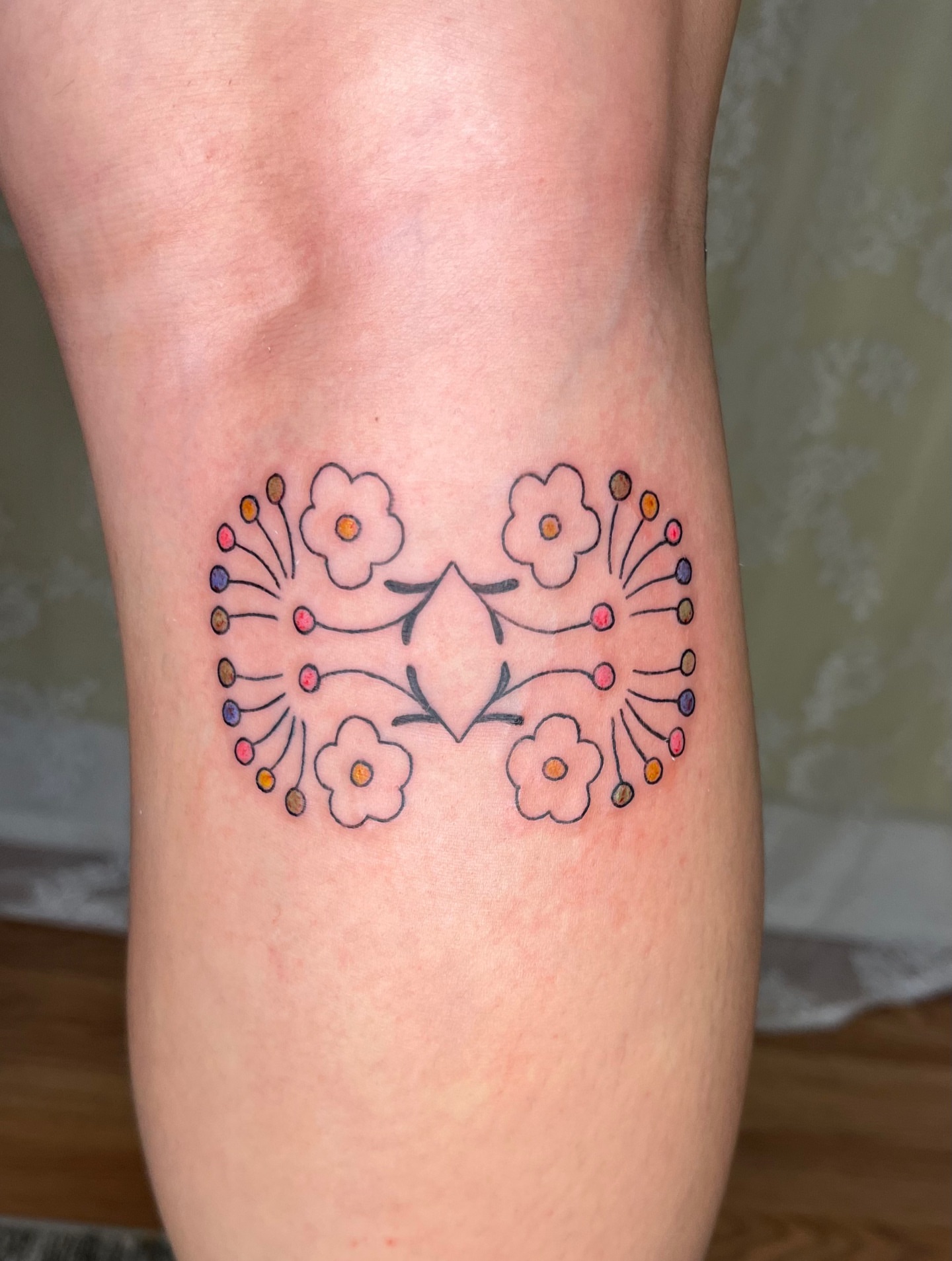 Floral arrangement geometric tattoo on the forearm by cait