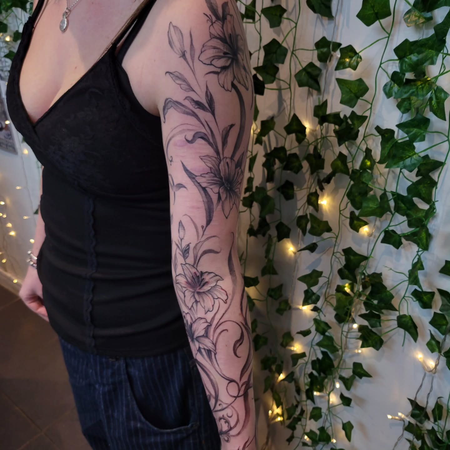 Floral design black and grey tattoo on the forearm by Uku Tattoos, Cambridge, England