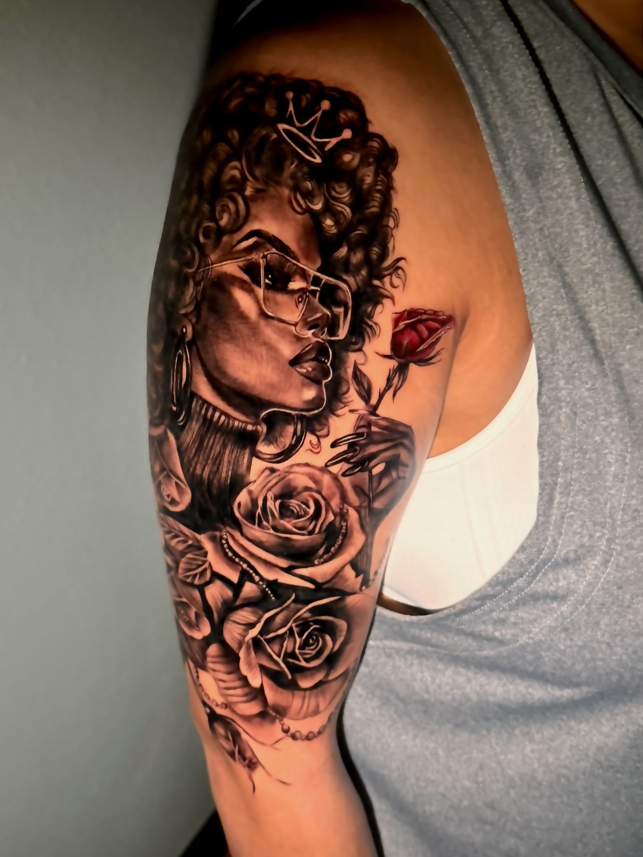 Woman with roses realism tattoo on the forearm by Tampa tattoo artist