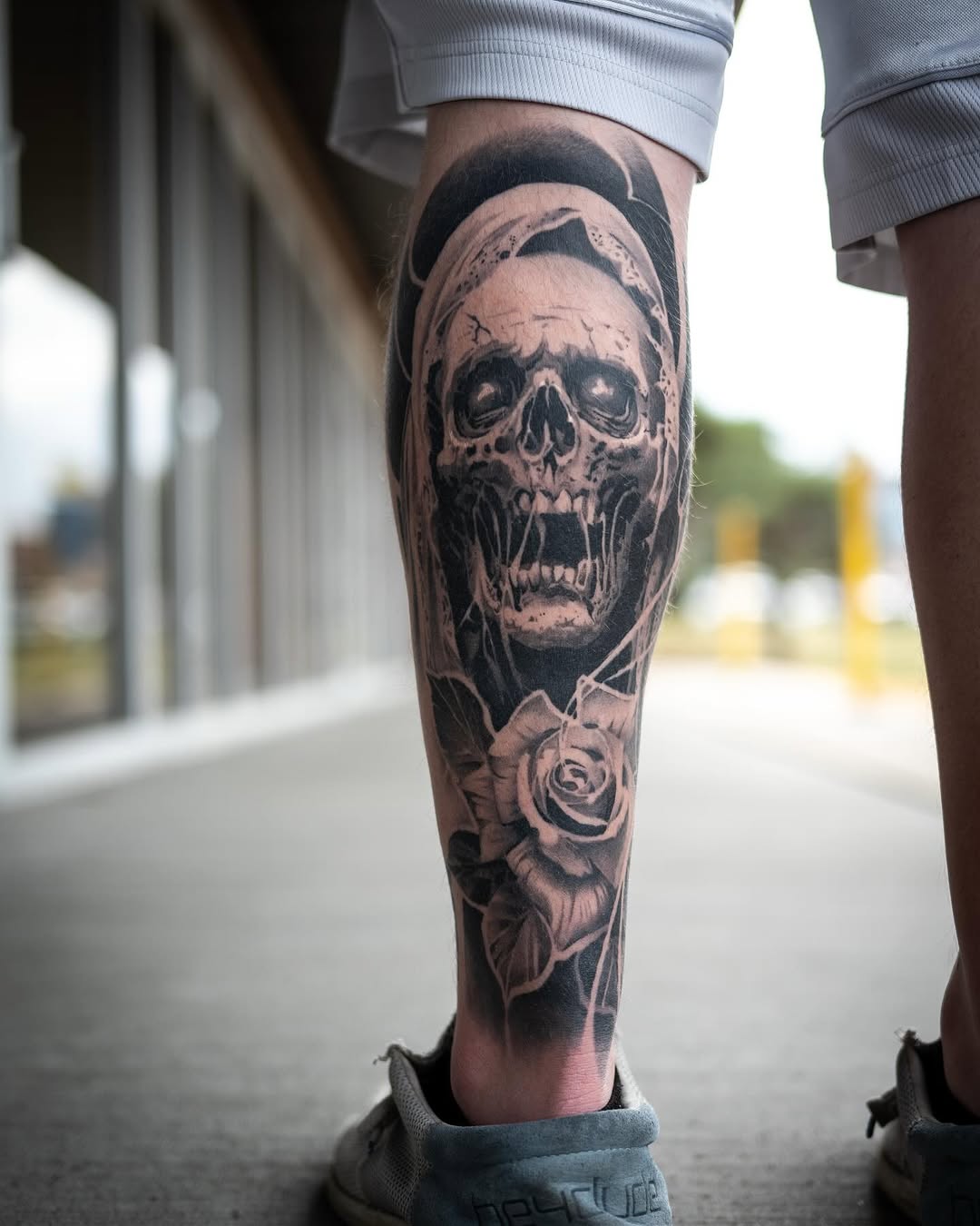 Skull and rose realism tattoo on the calf by Derek Hutchison, Des Moines, Iowa