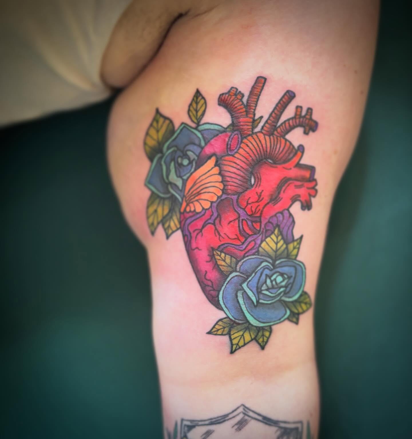 Anatomical heart with roses American traditional tattoo on the forearm by Runtz Tattoo, Greensboro, North Carolina