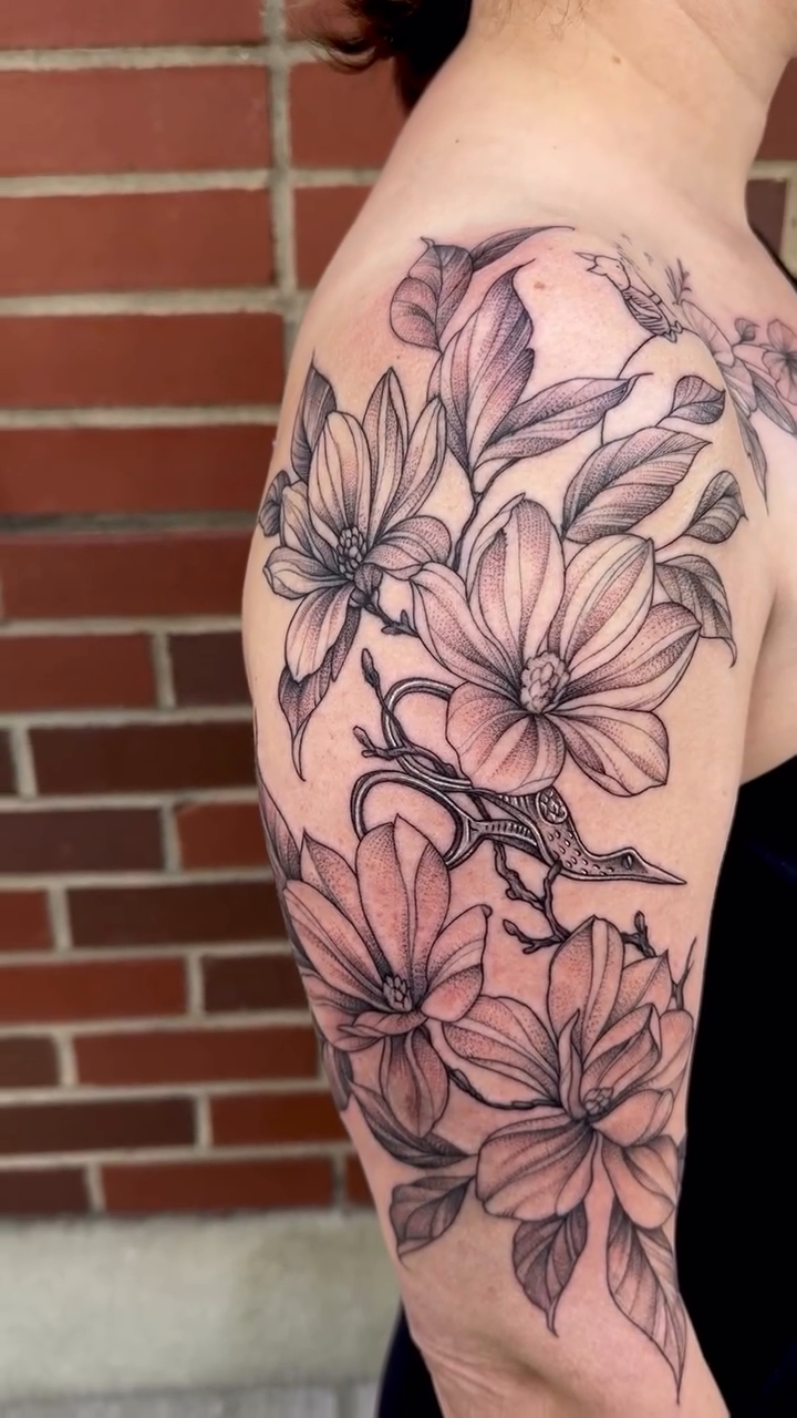 Magnolia flowers and branches fine line tattoo by Robert McCollum