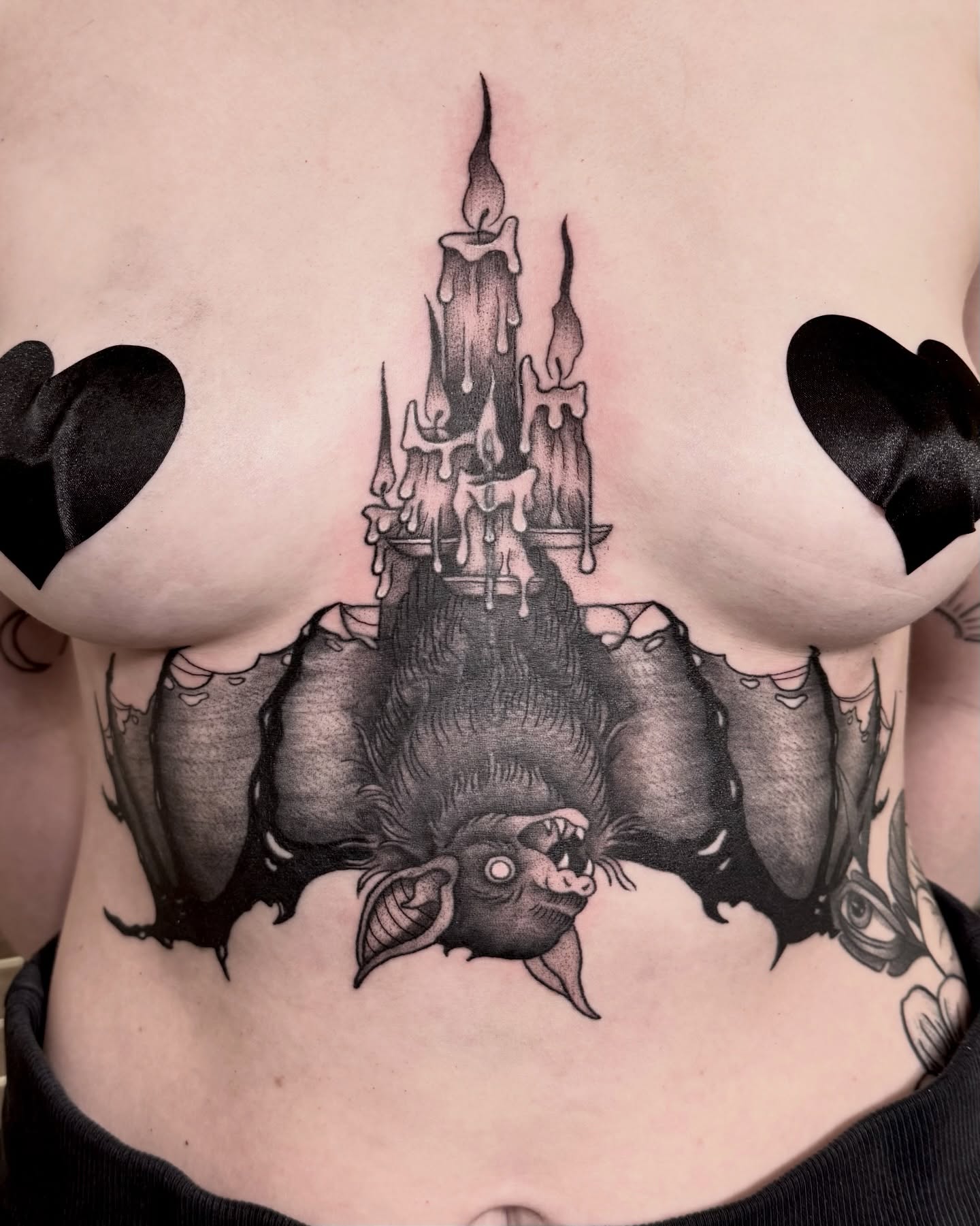 Bat and candles dark realism tattoo on the chest by Eden Allen