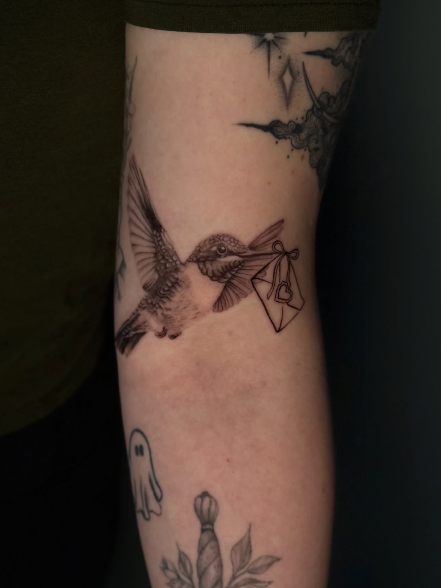 Hummingbird with envelope black and grey tattoo on the forearm by jaz🌀
