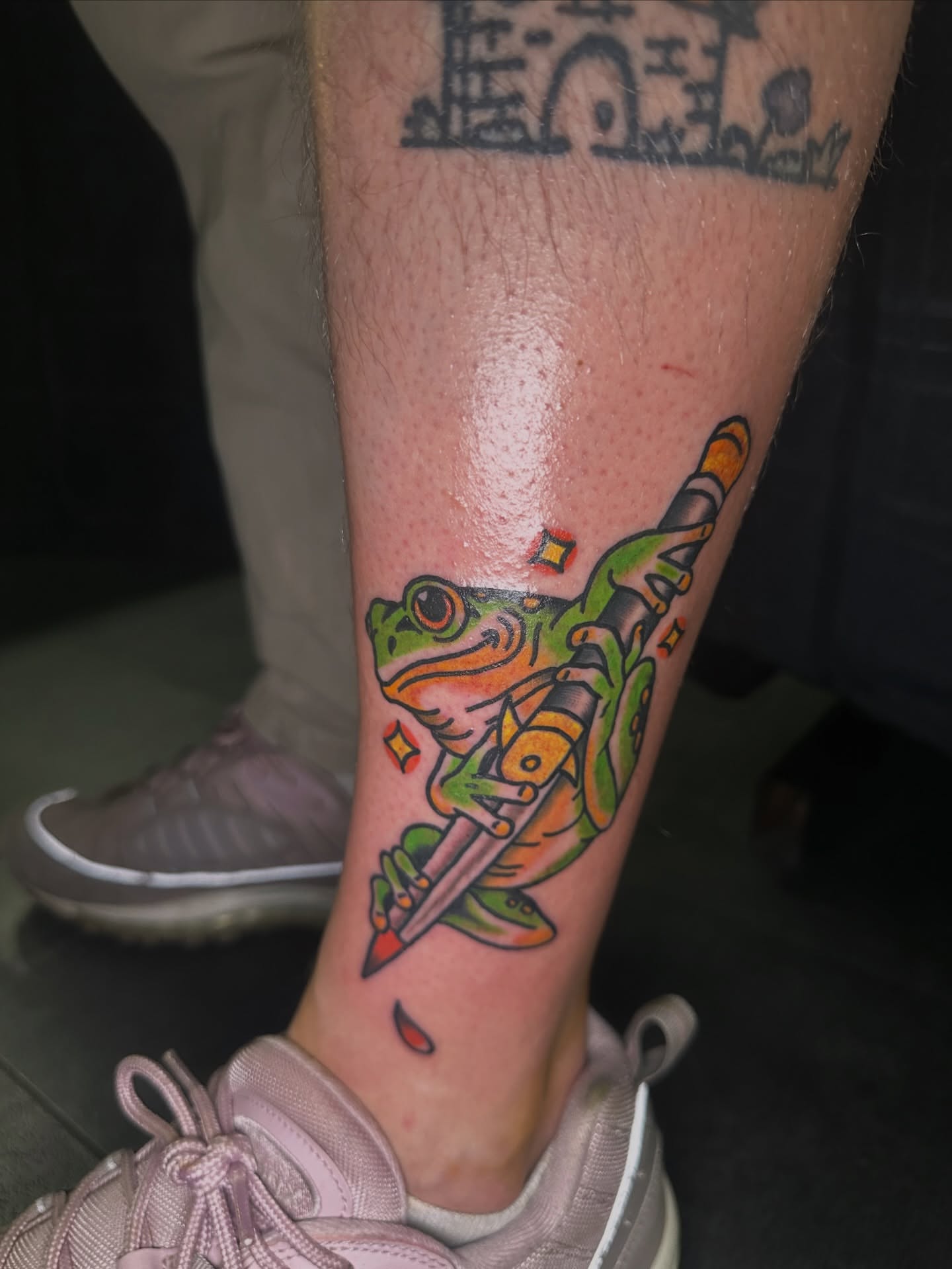 Frog with sword American traditional tattoo on the forearm by Drew’s Tattoos (NH)