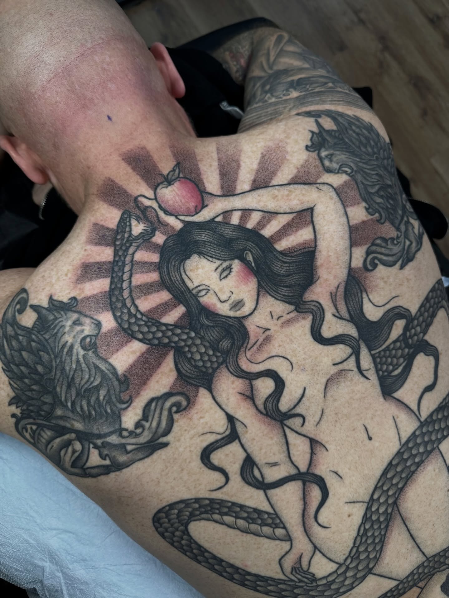 Serpent and woman realism tattoo on the back by Brooklyn Bailey