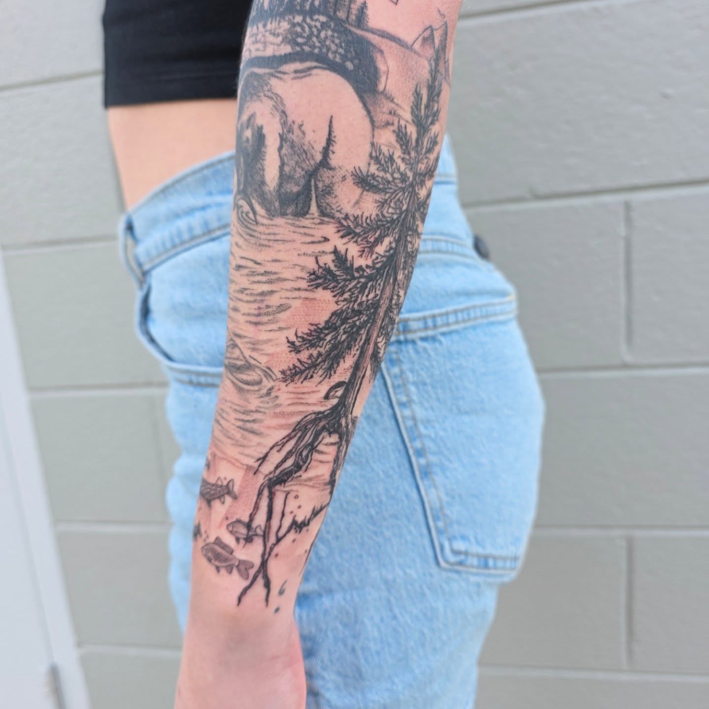 Man fishing realism tattoo on the forearm by Maggie
