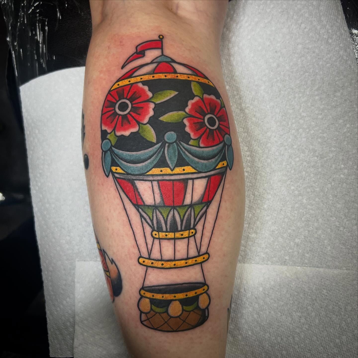 Hot air balloon American traditional tattoo on the forearm by Taylor Estrella