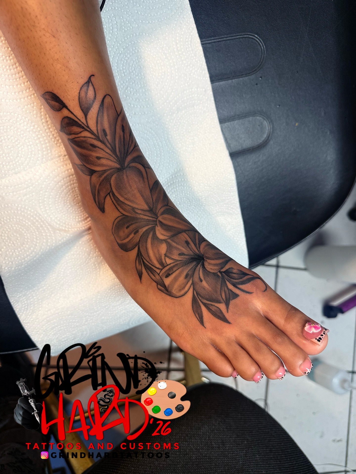 Floral design black and grey tattoo on the foot by GrindHard Quen