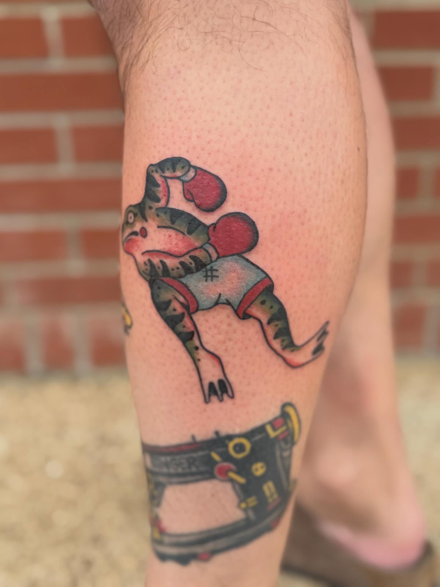 Frog in roller skates American traditional tattoo on the calf by Aly Rucker, Murfreesboro, Tennessee