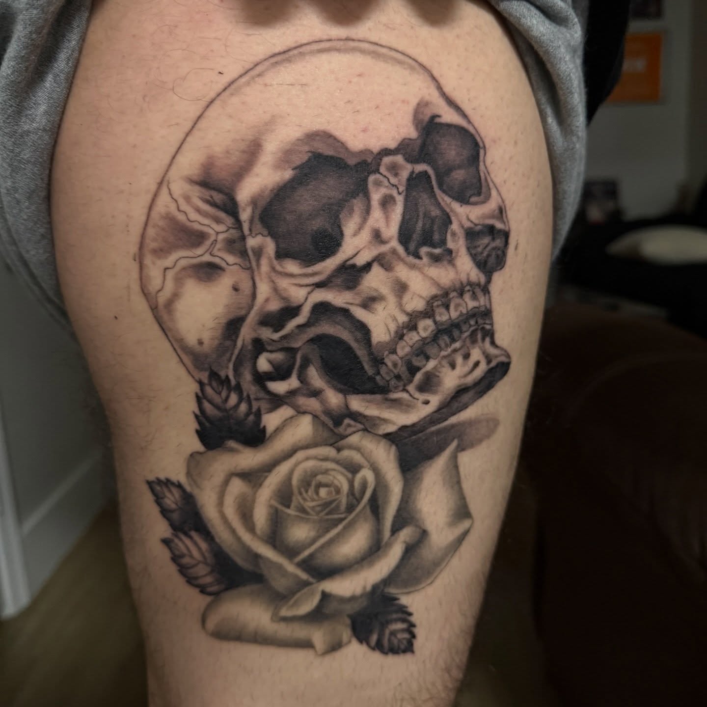 Skull and rose realism tattoo on the thigh by Kayla Jackson, Phoenix, Arizona