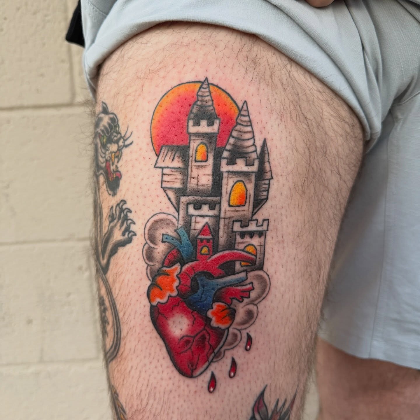 Castle and heart American traditional tattoo on the thigh by Kayla Jackson, Phoenix, Arizona