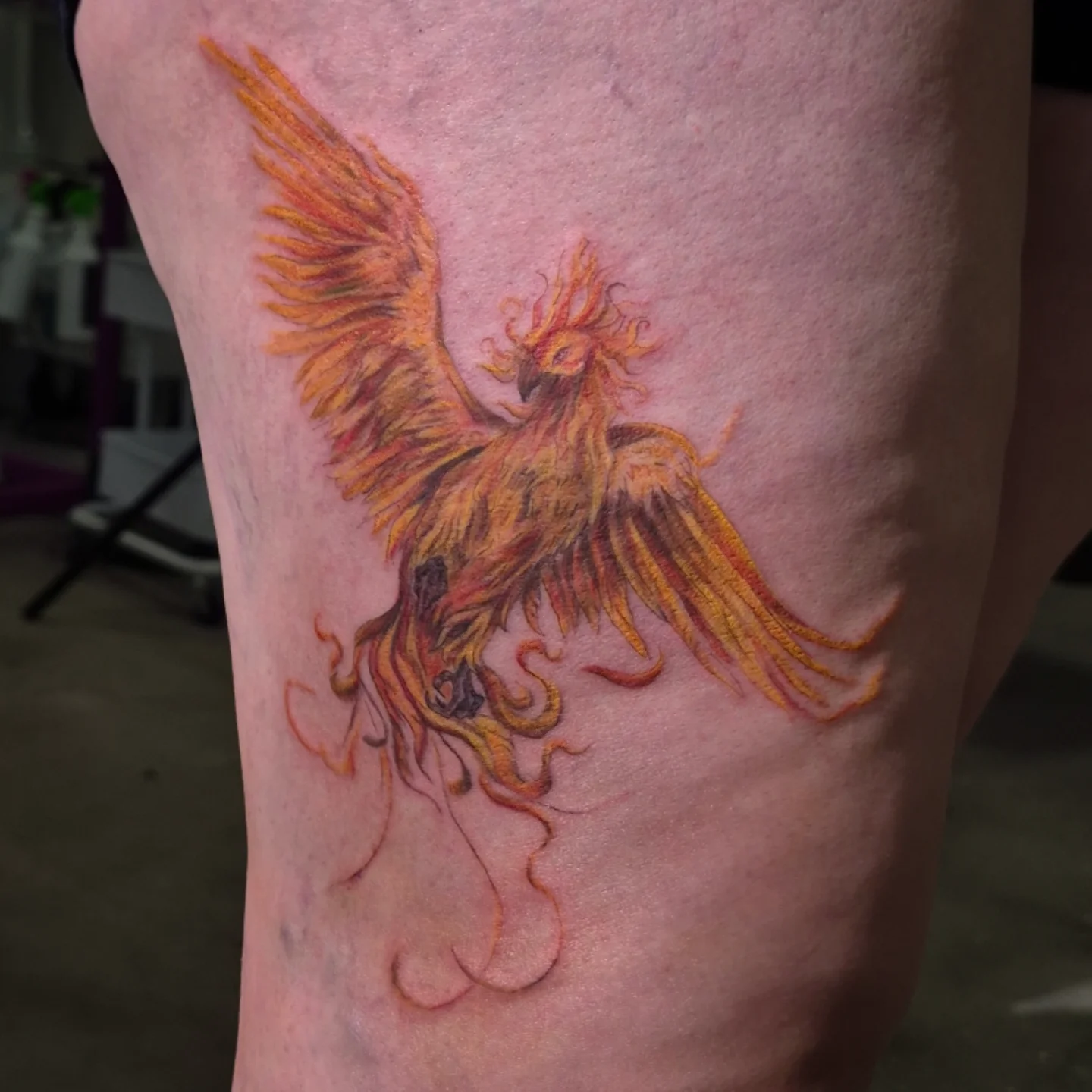 Phoenix new school tattoo on the thigh by Lydia Kiley