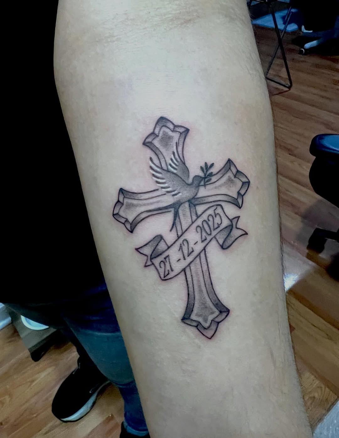 Cross with dove and date tattoo on the forearm by Gerardo Galicia, New York, New York