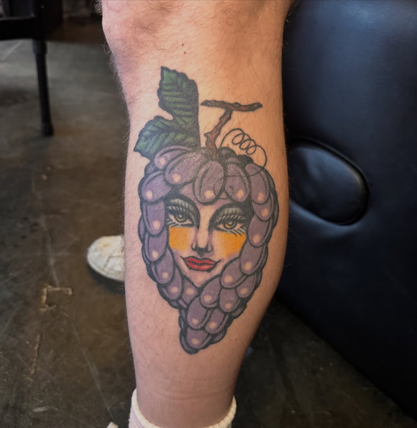Grape cluster American traditional tattoo on the forearm by Kyle Simmons