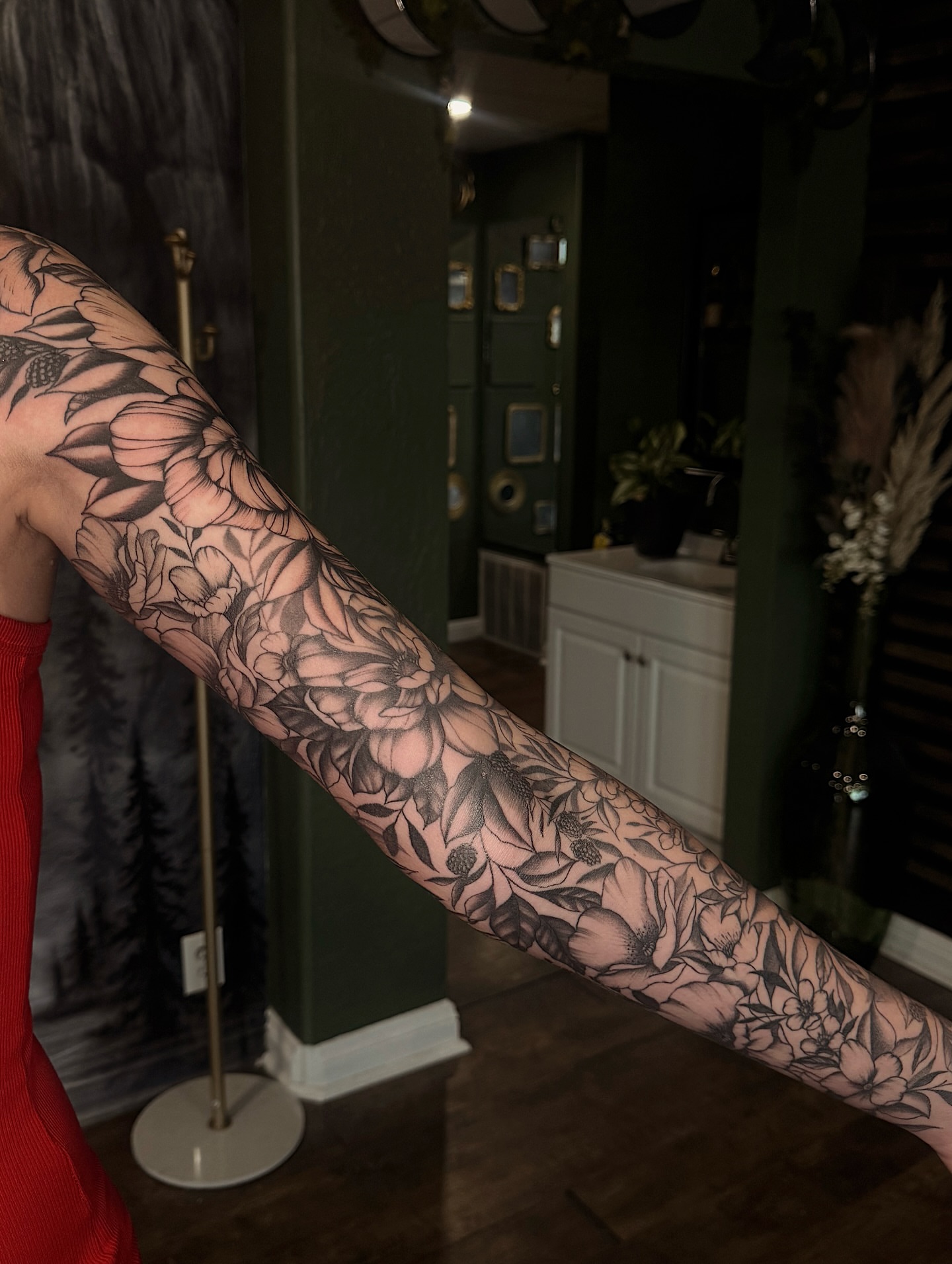 Floral sleeve black and grey tattoo on the forearm by Breanna Werner