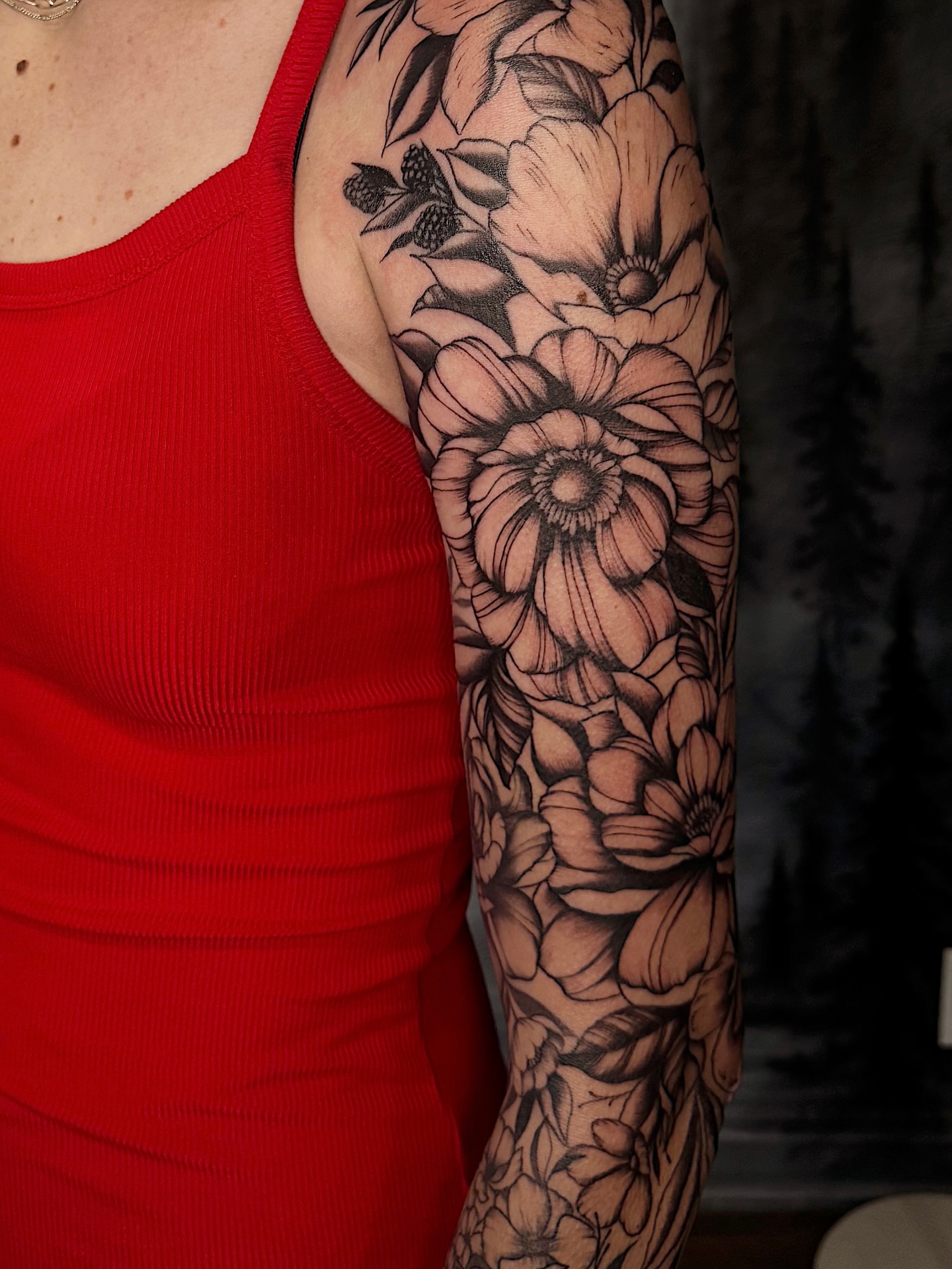 Floral bouquet black and grey tattoo on the upper arm by Breanna Werner