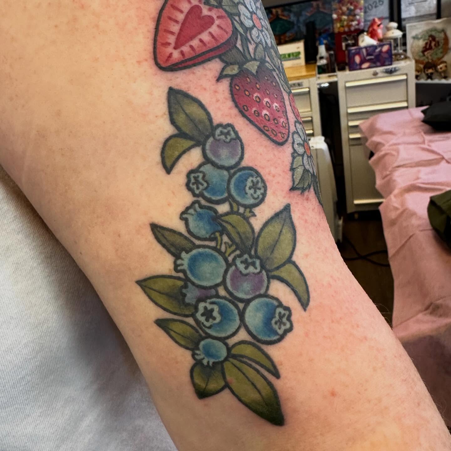 Blueberries American traditional tattoo on the forearm by Katie Beth