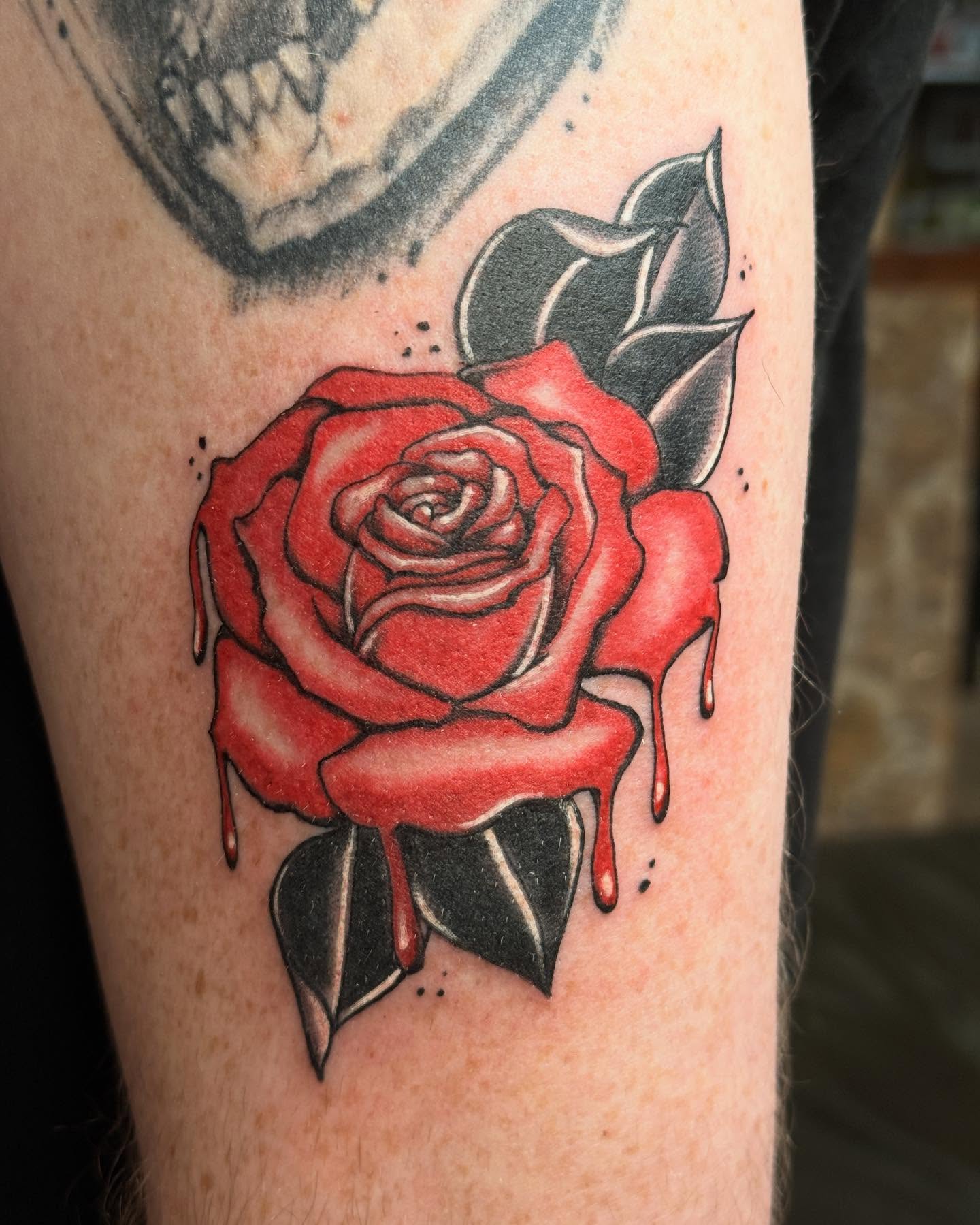 Red rose American traditional tattoo on the forearm by Megan Sue Causemaker