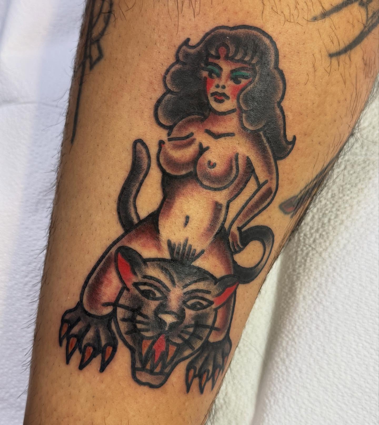 Woman and panther American traditional tattoo on the forearm by lindsay