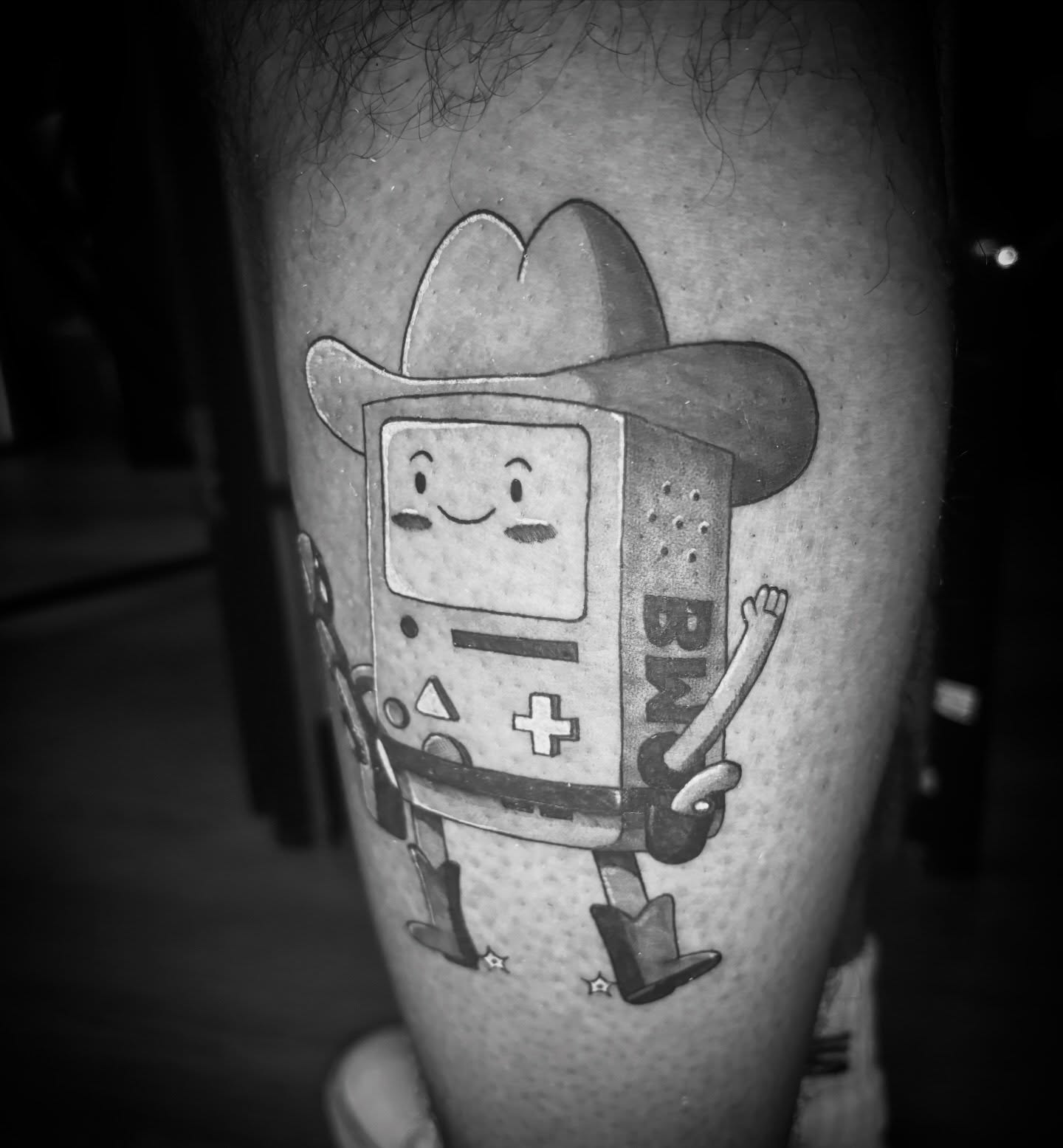 BMO cowboy black and grey tattoo on the forearm by Kiwi🌱☀️