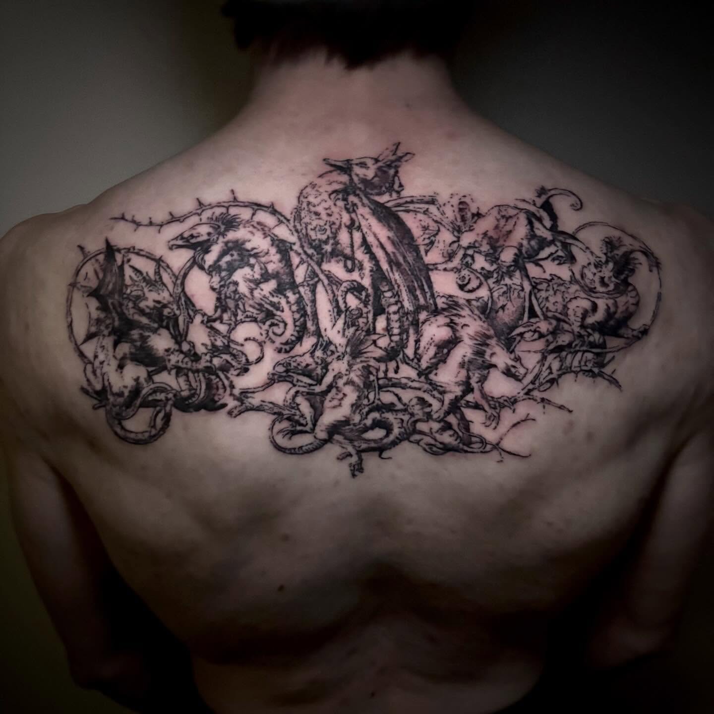 Mythical creatures black and grey tattoo on the back by unknown liquids tattoo