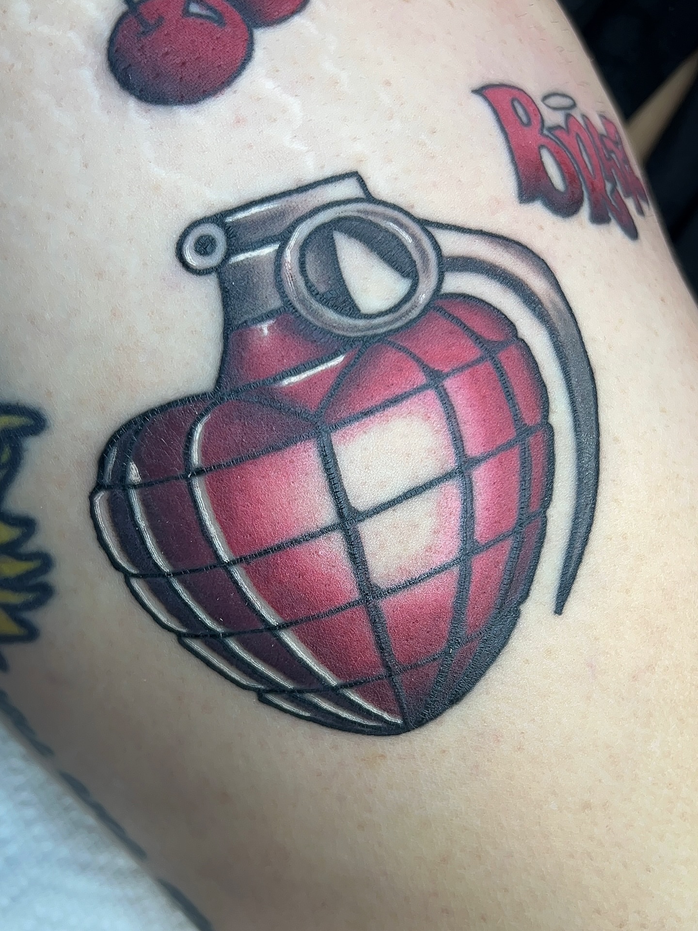 Hand grenade American traditional tattoo on the thigh by 𝑴𝒂𝒚𝒂𖤐𝑫𝒆𝑽𝒊𝒏𝒆, Dayton, Ohio