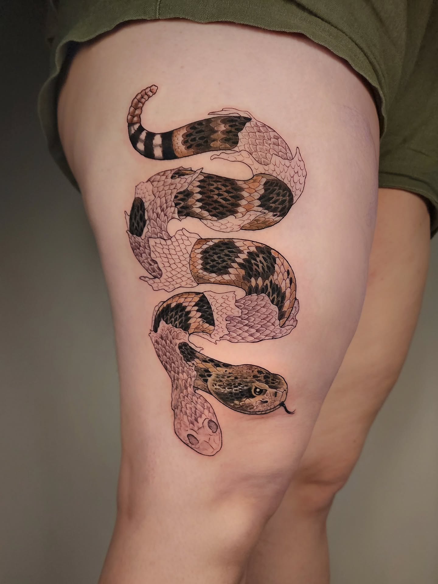 Snake realism tattoo on the thigh by Whitney Caskey